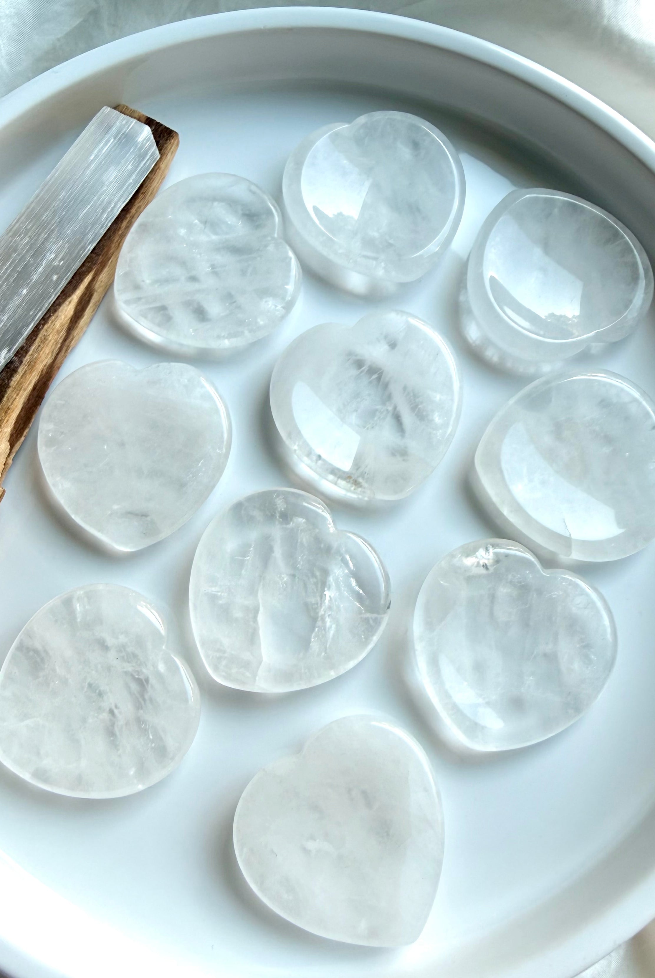 clear quartz heart stones displayed on dish for chakra healing clarity and energy work