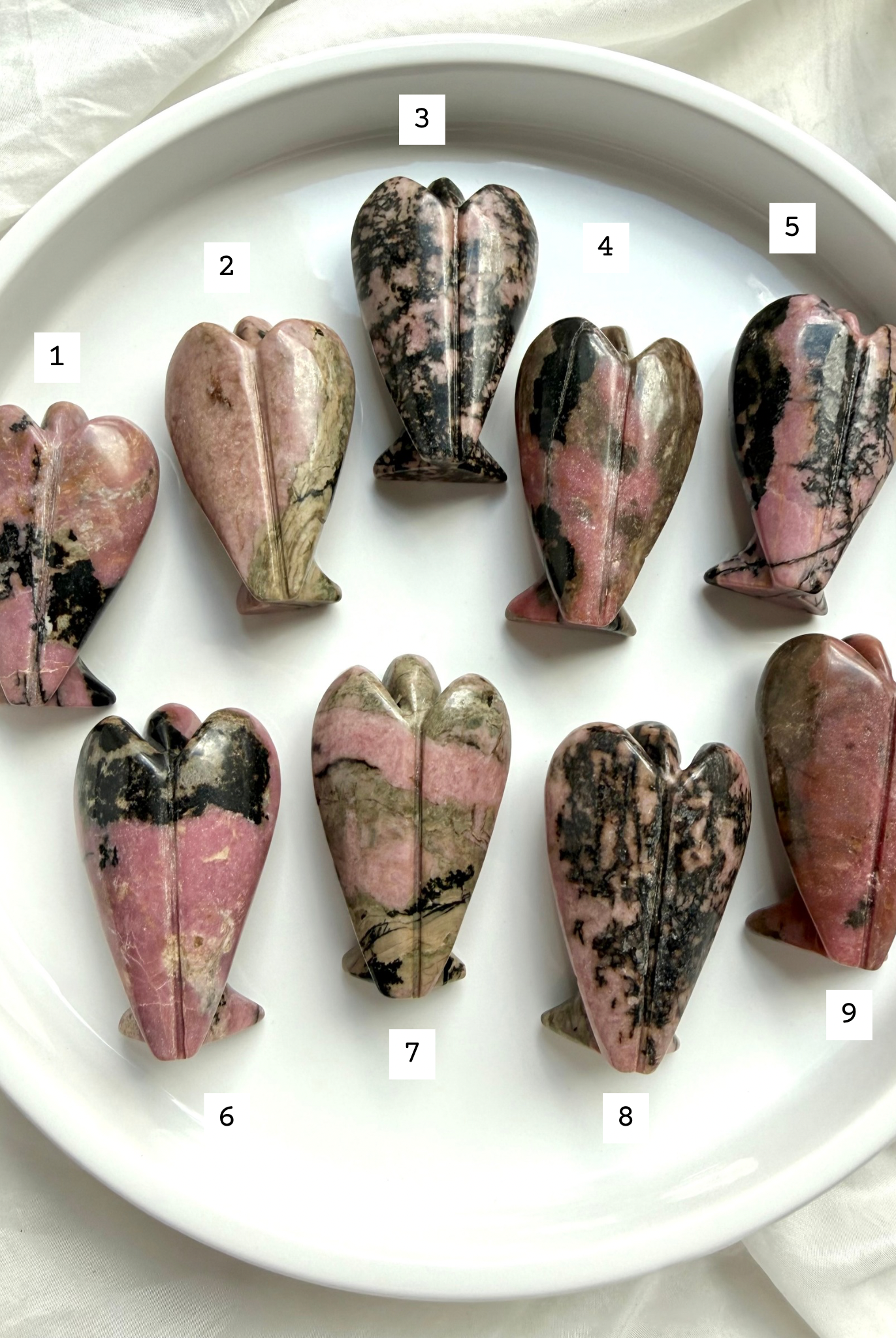 choose your own Rhodonite angel carvings numbered 1–9 showing back view with natural matrix patterns
