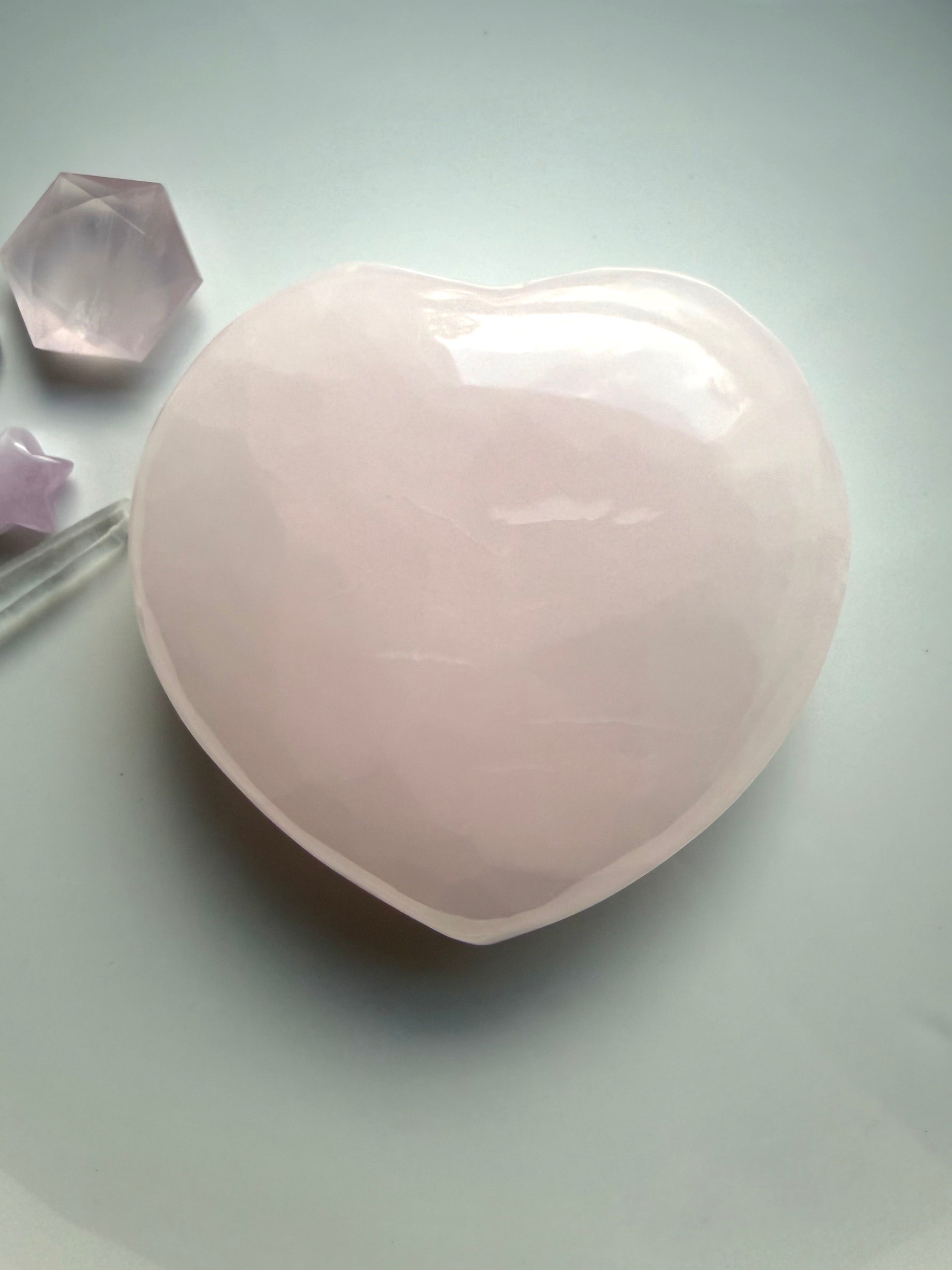Polished Mangano Calcite heart meditation stone with smooth rounded shape and calming heart centered energy