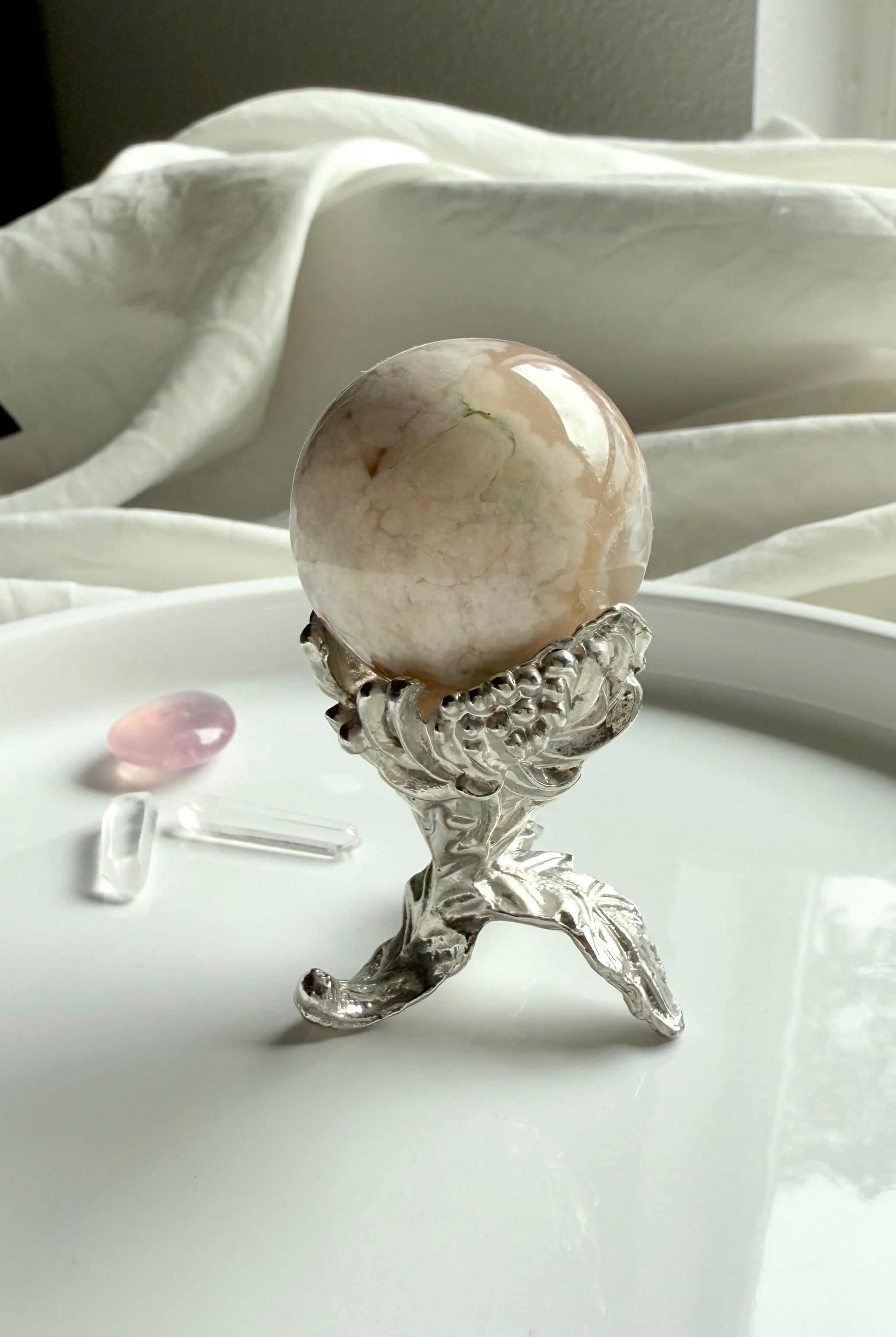 Our elegant botanical mini sphere stand fits small crystal spheres, shown with a flower agate sphere