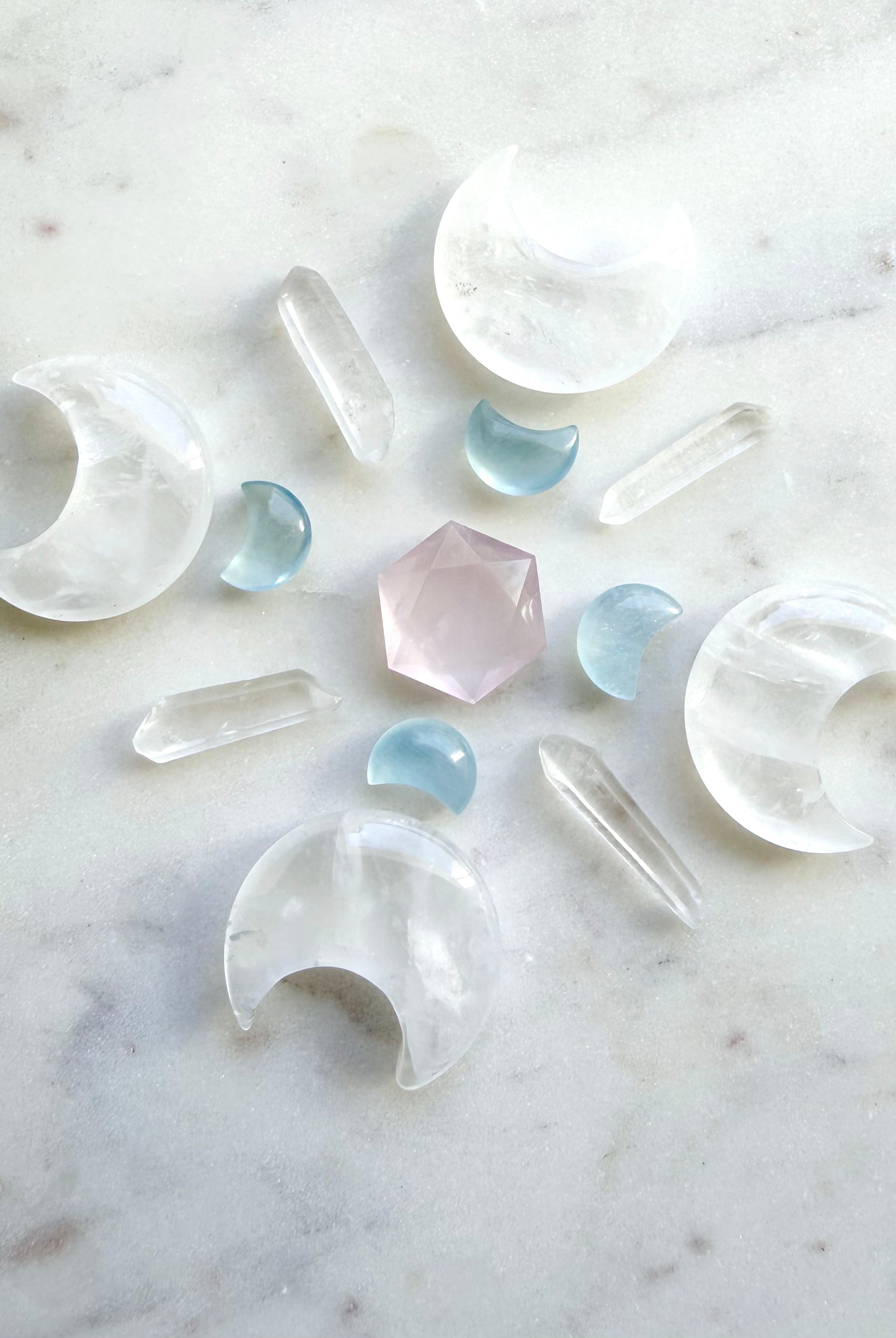 Crystal grid featuring clear quartz moons, quartz points, rose quartz, and aquamarine moon carvings — a layout for peace, clarity, and divine connection.