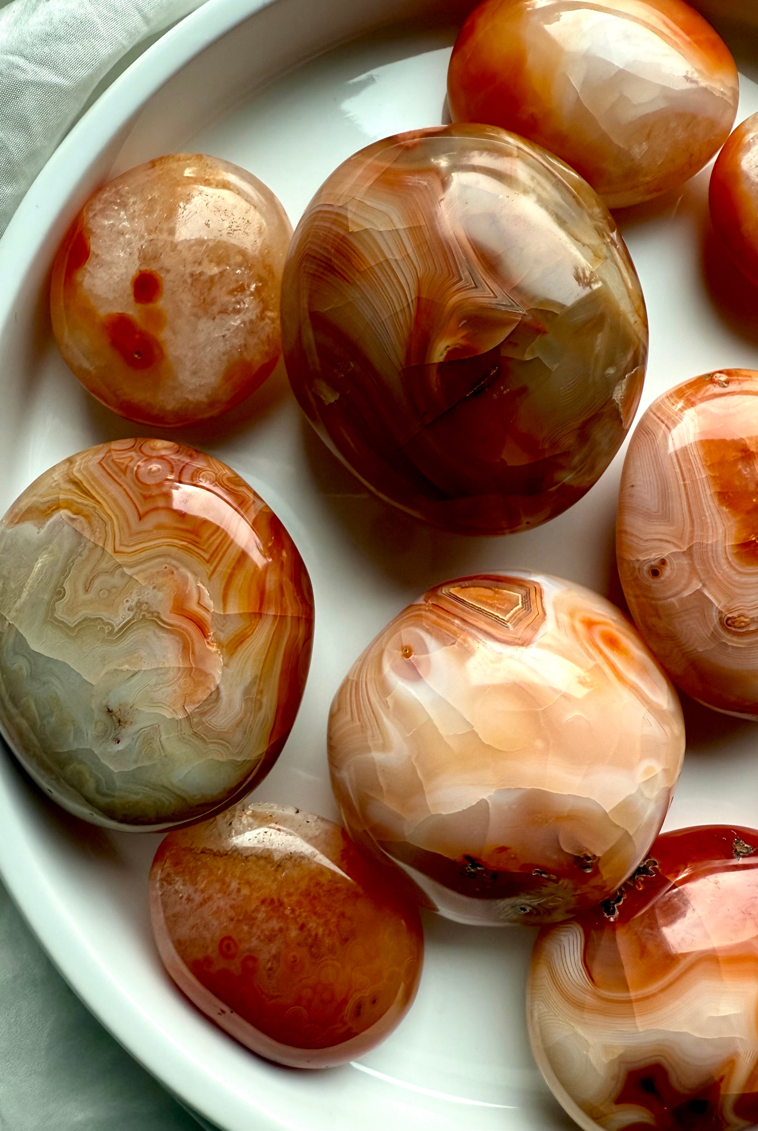 Carnelian palm stones with fiery banding + druzy details — energizing sacral chakra crystals for joy + creativity
