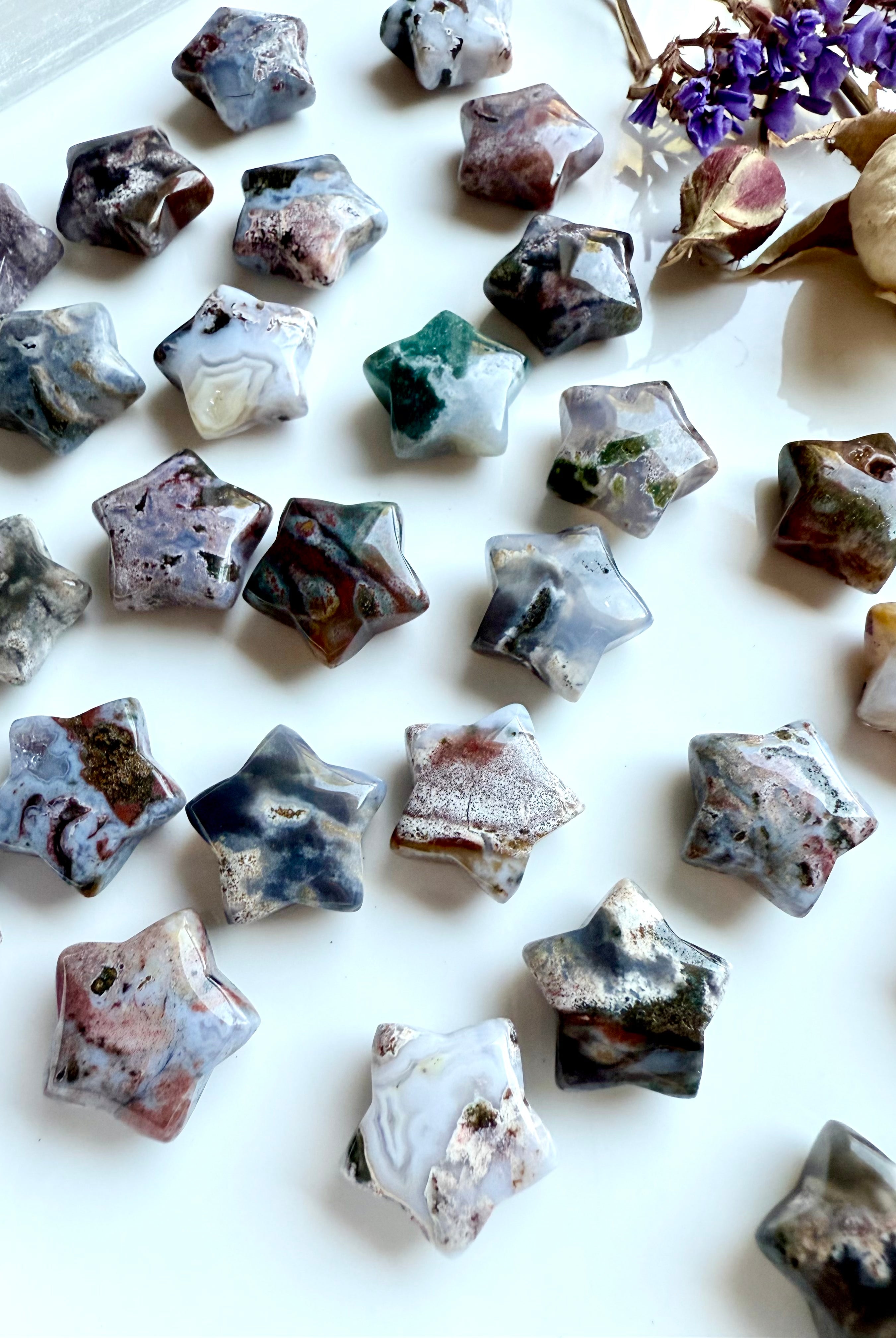 Group of mini Ocean Jasper star carvings with multicolored patterns and textures