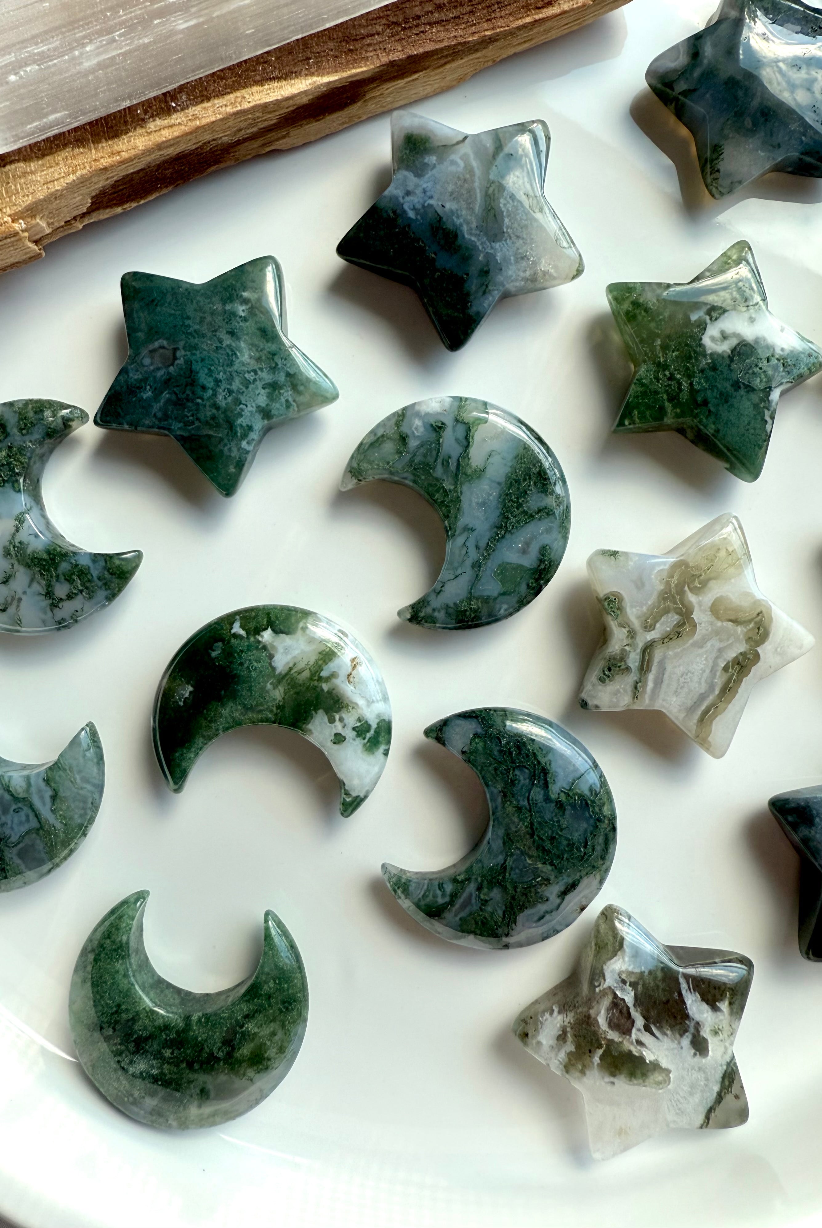 Moss Agate stars and moons in various green and white patterns — grounding crystal carvings for emotional balance, Earth energy, and heart chakra harmony.