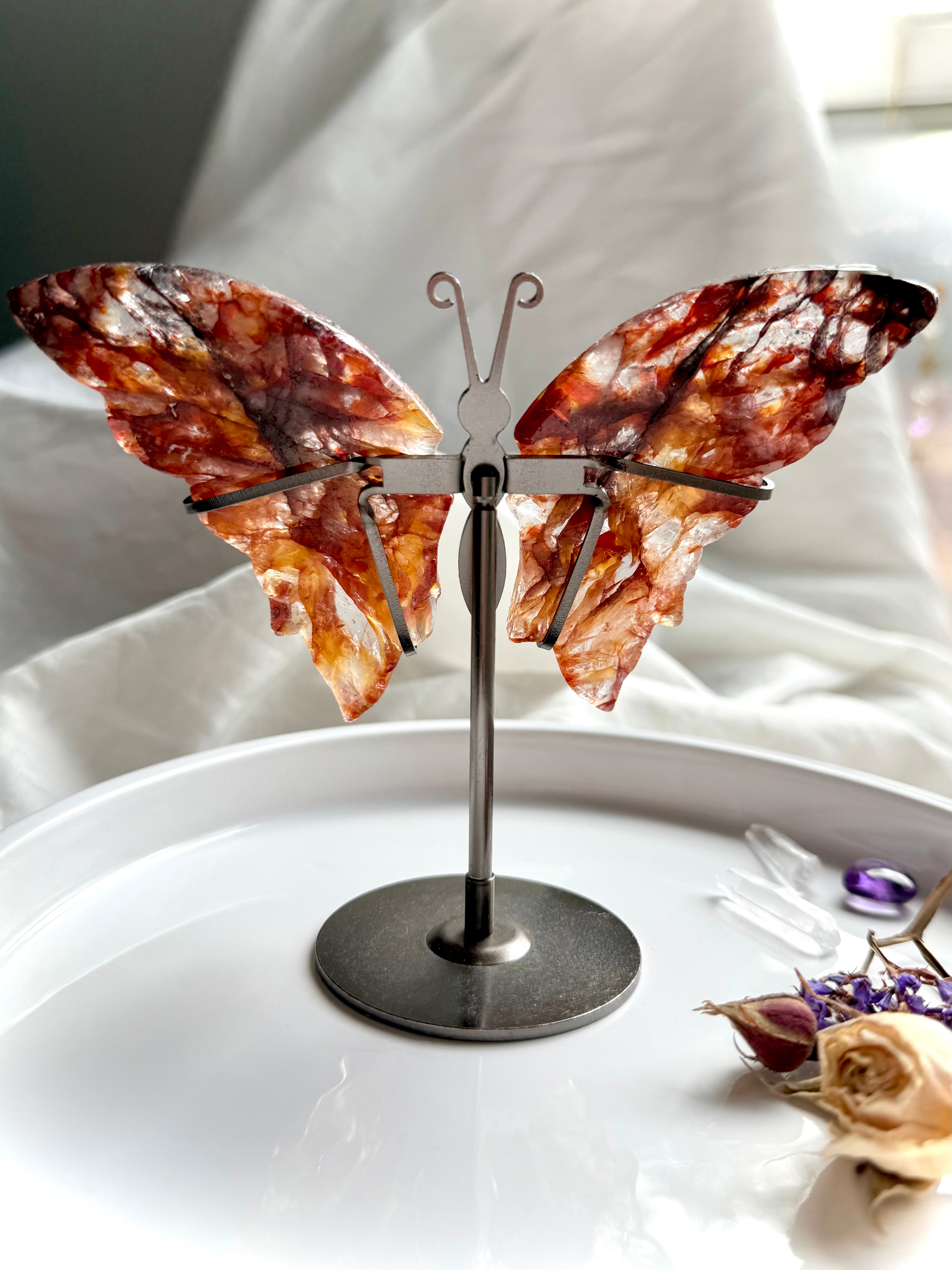 Back view of Fire Quartz butterfly wings on metal stand, carved from hematoid quartz with fiery red tones.