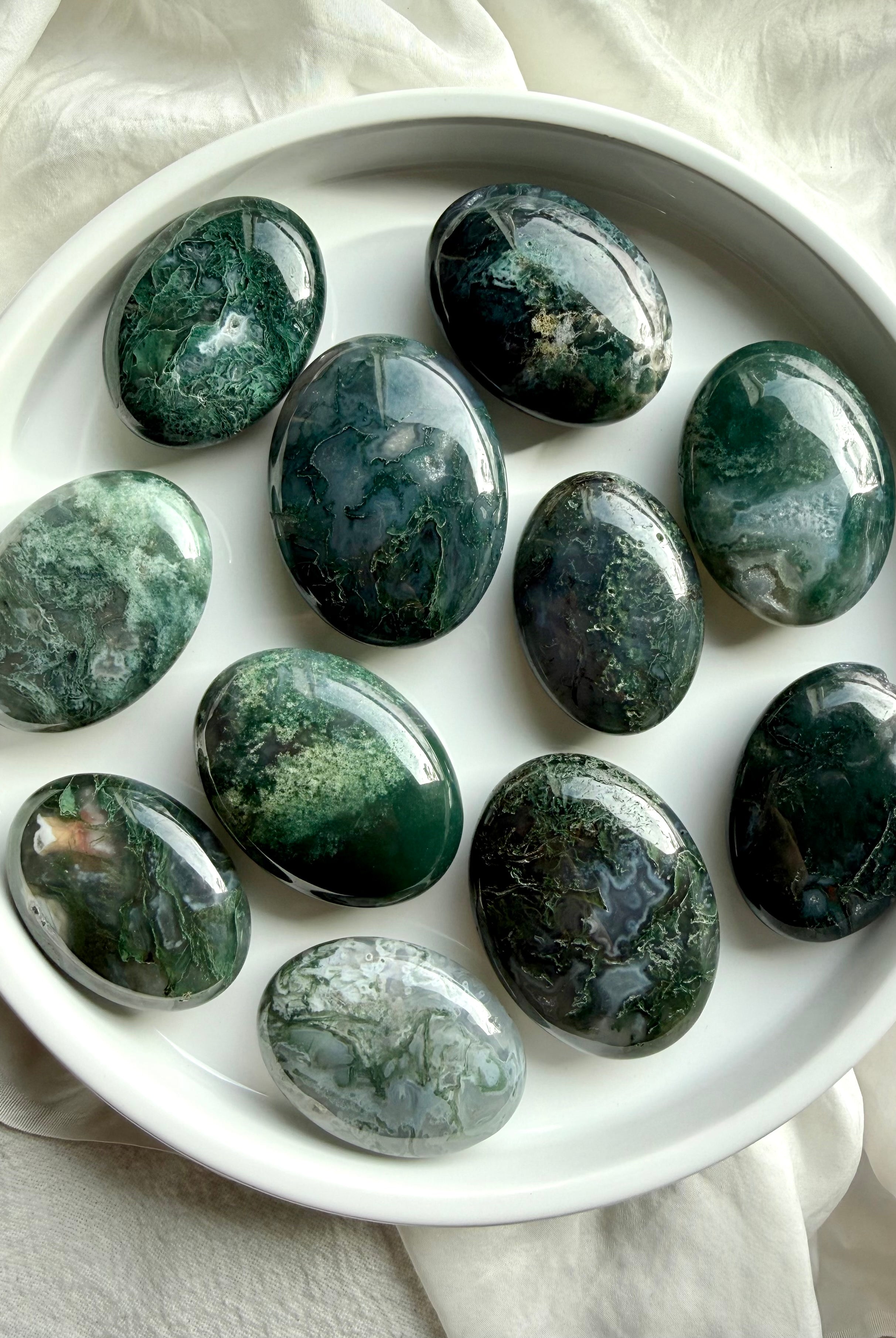 Moss agate palm stones with green dendritic inclusions, polished grounding crystals for calm, emotional balance, and meditation