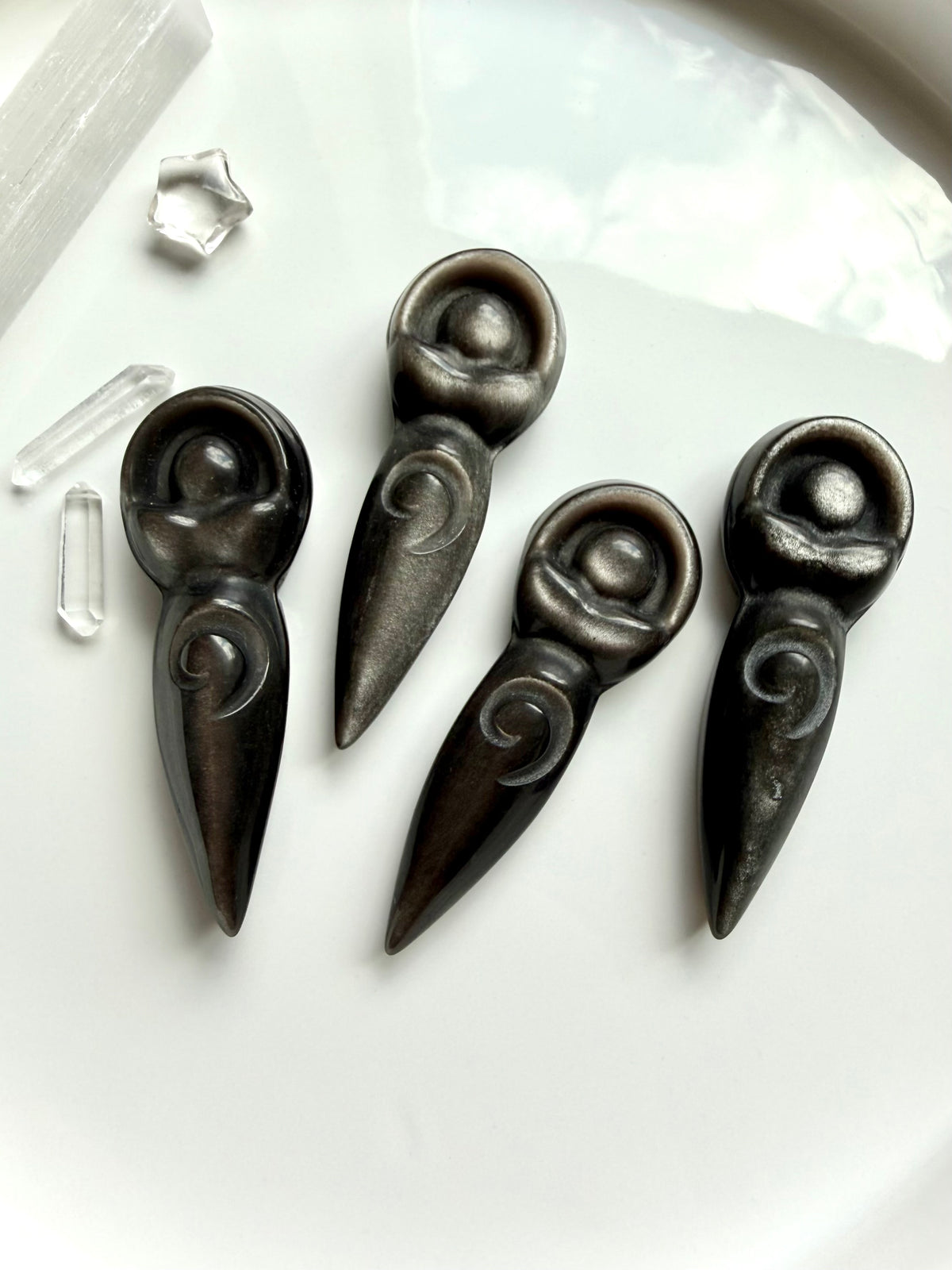 Silver Sheen Obsidian spiral goddess carvings showing unique silver shimmer and detailed carved design
