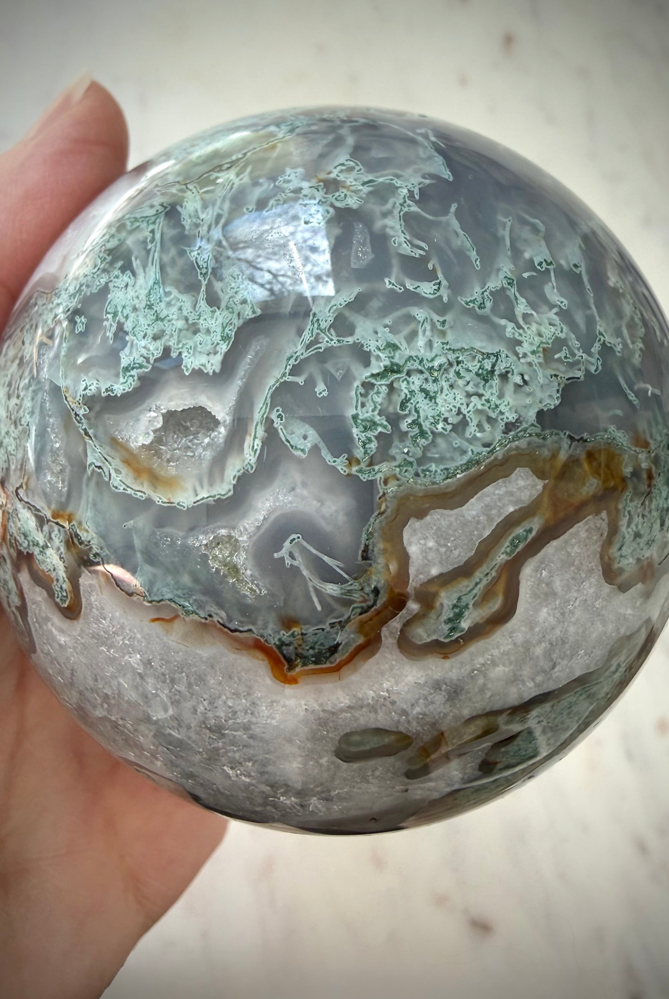 75mm Moss Agate sphere showing natural Quartz veins, earthy green patterns, and polished finish