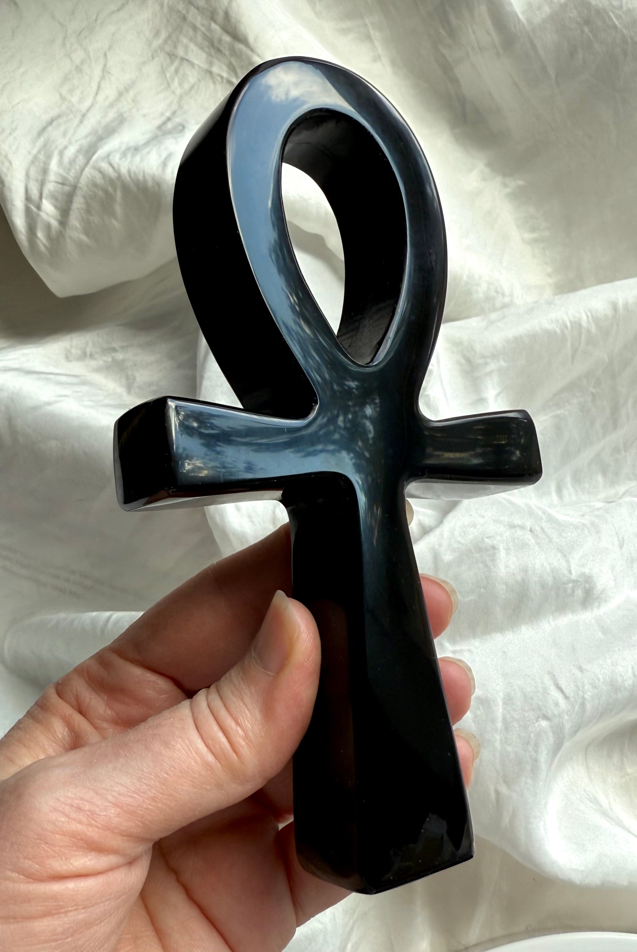 Black obsidian ankh with smooth, reflective finish — gemstone carving for energy healing, shadow work, and grounding.