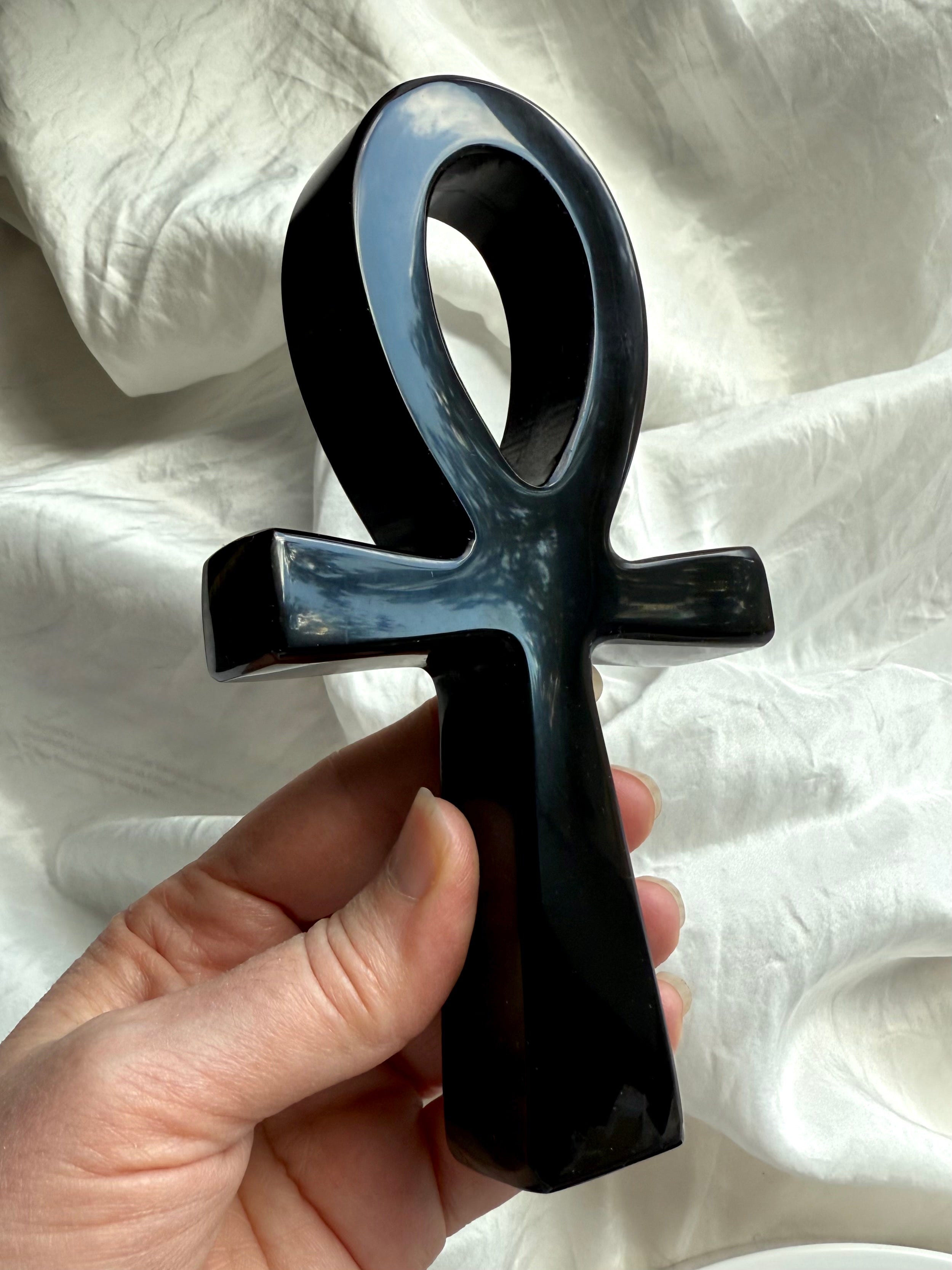 Black obsidian ankh with smooth, reflective finish — gemstone carving for energy healing, shadow work, and grounding.