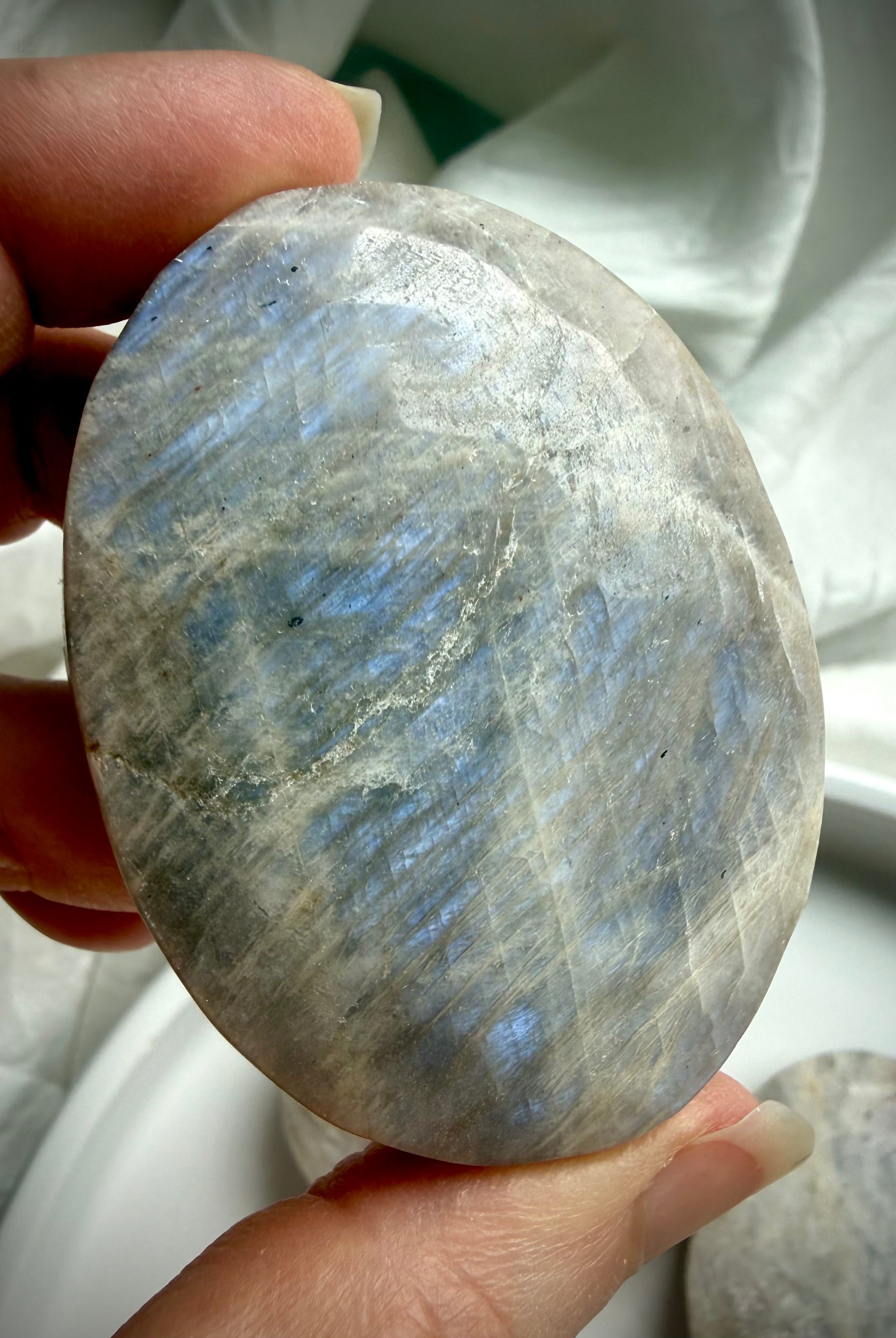 belomorite moonstone crystal palm stone with luminous blue flash and feldspar shimmer