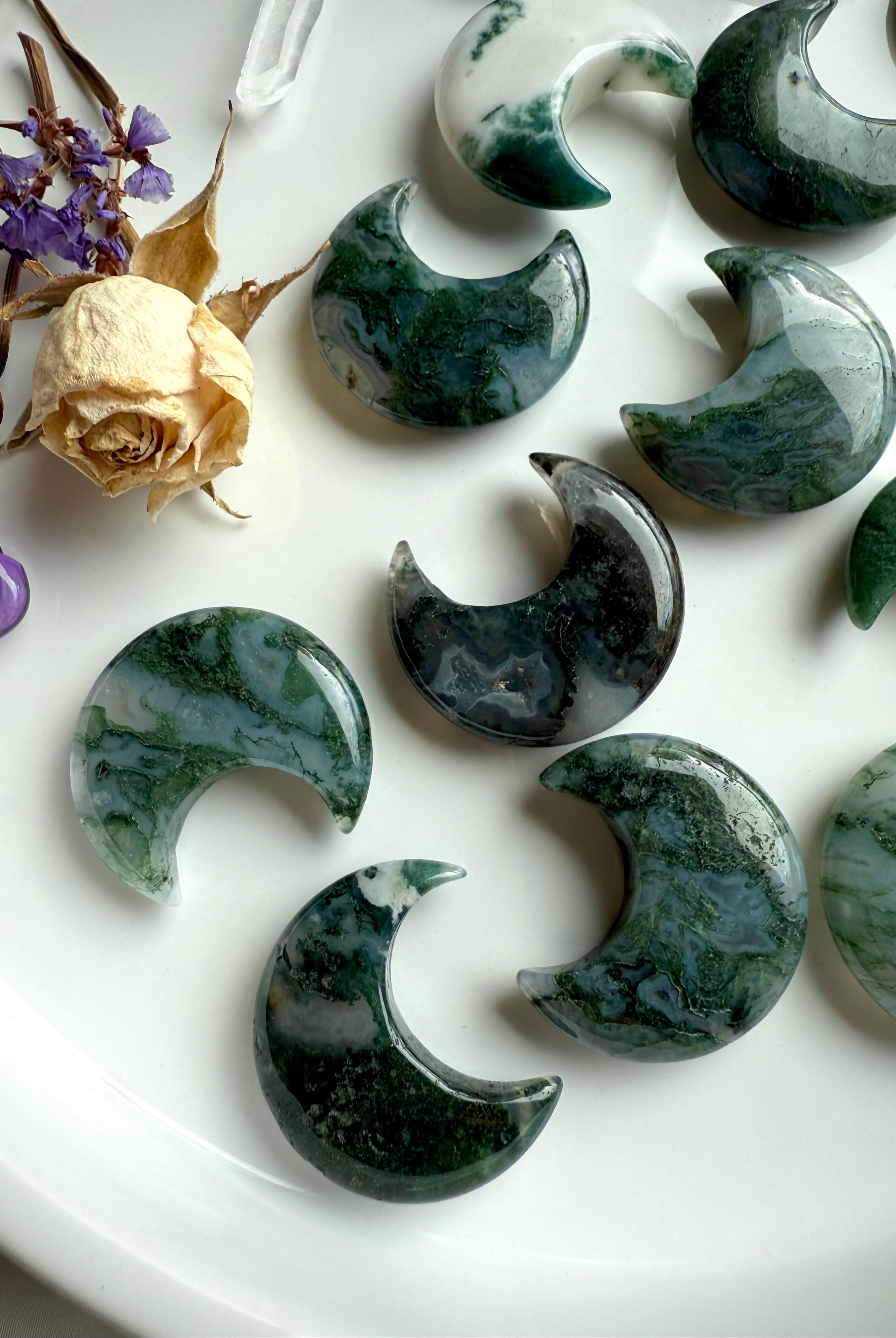 Close-up of Moss Agate crystal moons showing variation in color, translucence, and mossy inclusions.