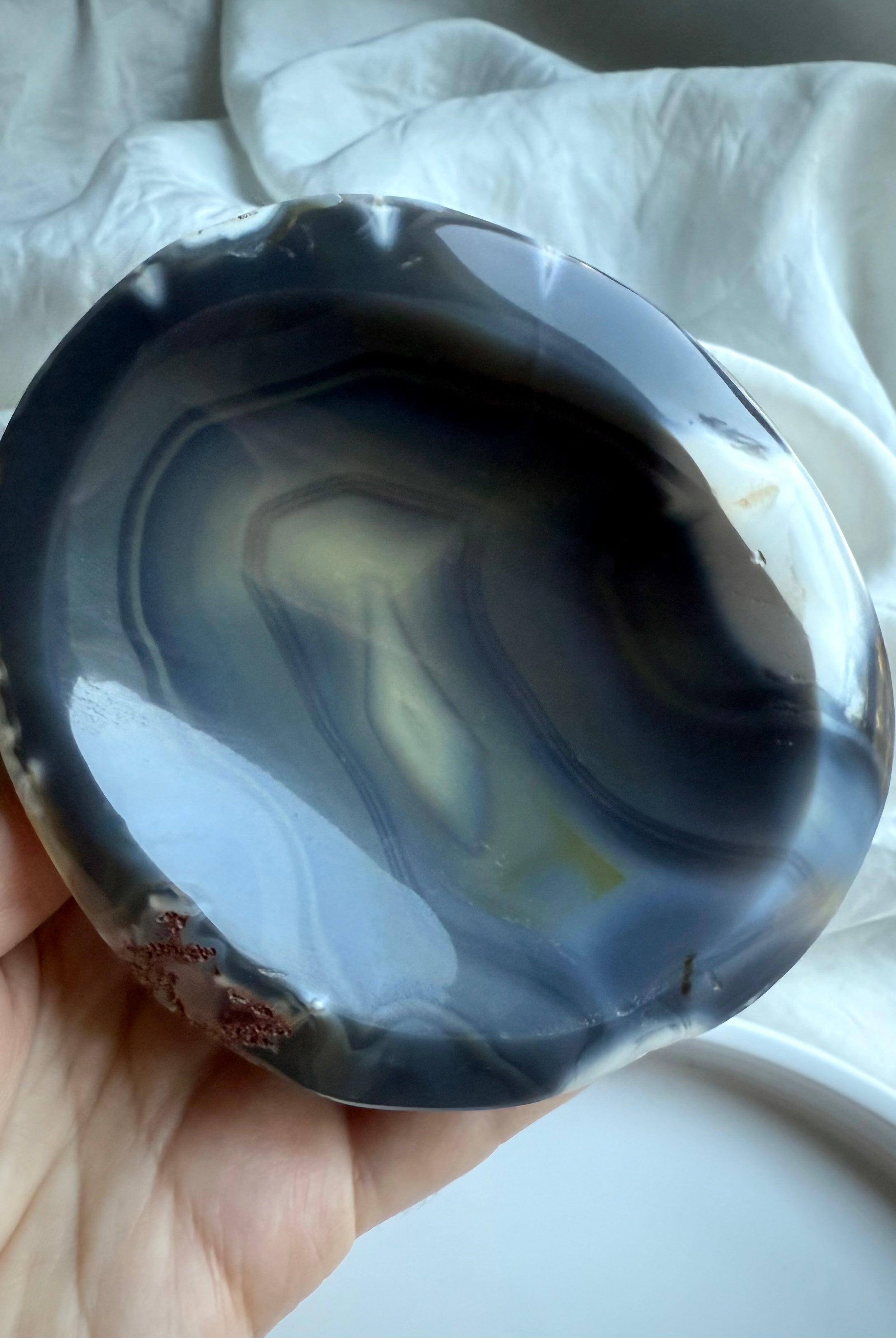 Orca Agate offering bowl with layered oceanic bands in charcoal, cream, and sand tones — grounding stone bowl for altar work and protective rituals.