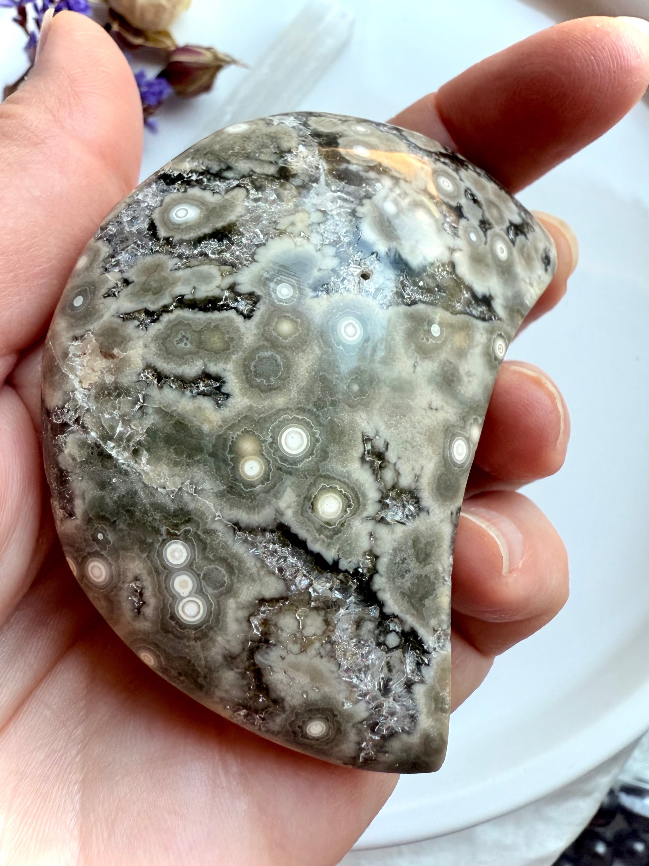 Crescent Ocean Jasper crystal moon from Madagascar with orbicular rings and druzy pocket shown in natural light