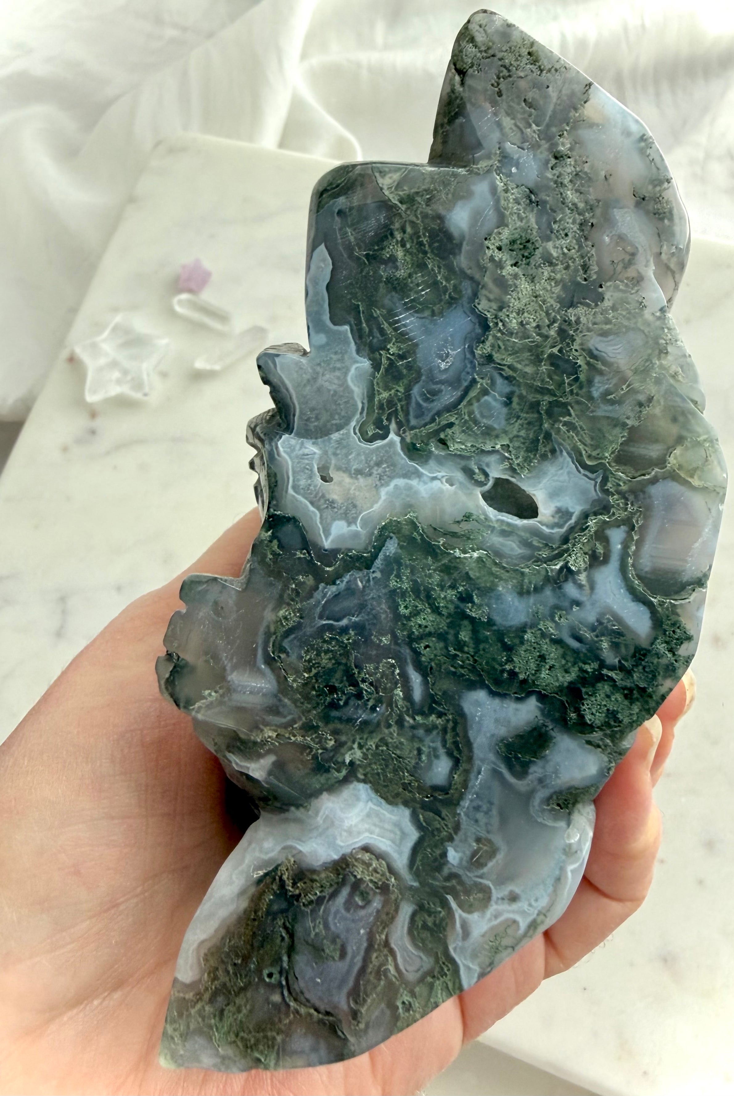 Underside and back of a Large Moss Agate Laughing Buddha carving showing natural Moss Agate patterns