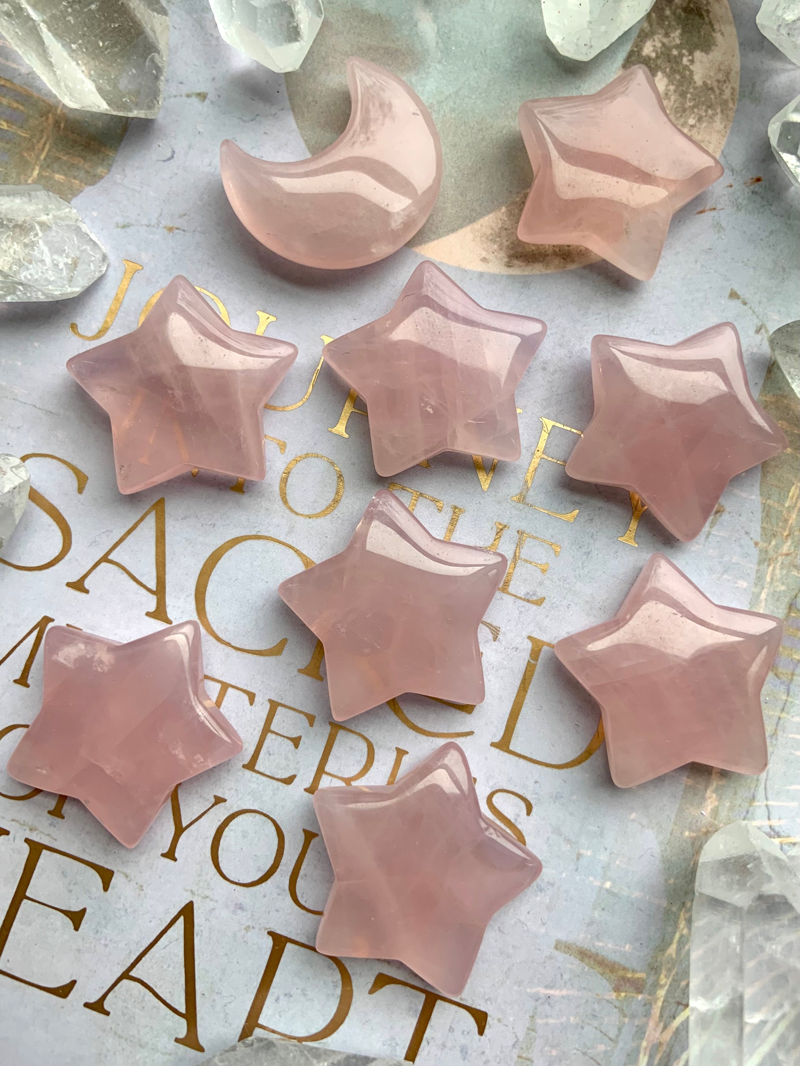 Small rose quartz star carvings on a pale lilac journal with gold text. Heart Chakra crystals for peace, calm, & emotional healing.