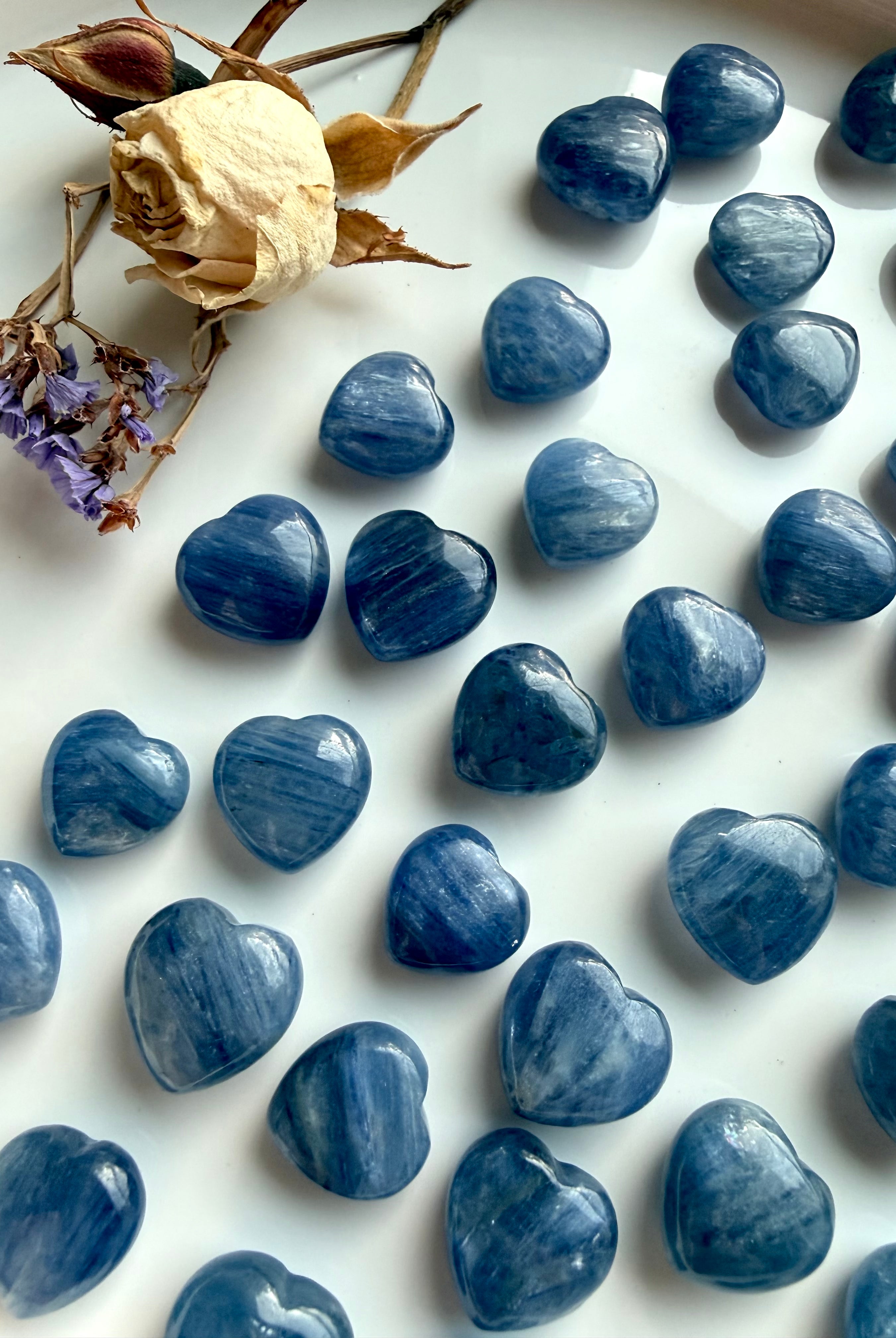Assorted mini Blue Kyanite crystal hearts in various sizes with natural variation in color, shimmer and inclusions