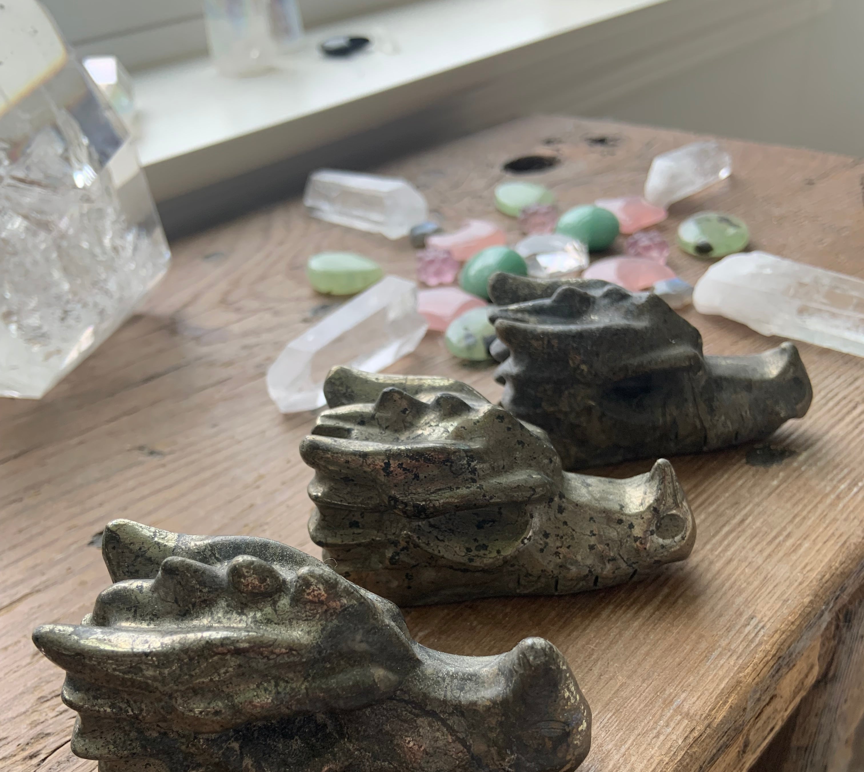 Hand-carved pyrite crystal dragons with natural metallic shimmer, symbolic guardians for wealth and confidence