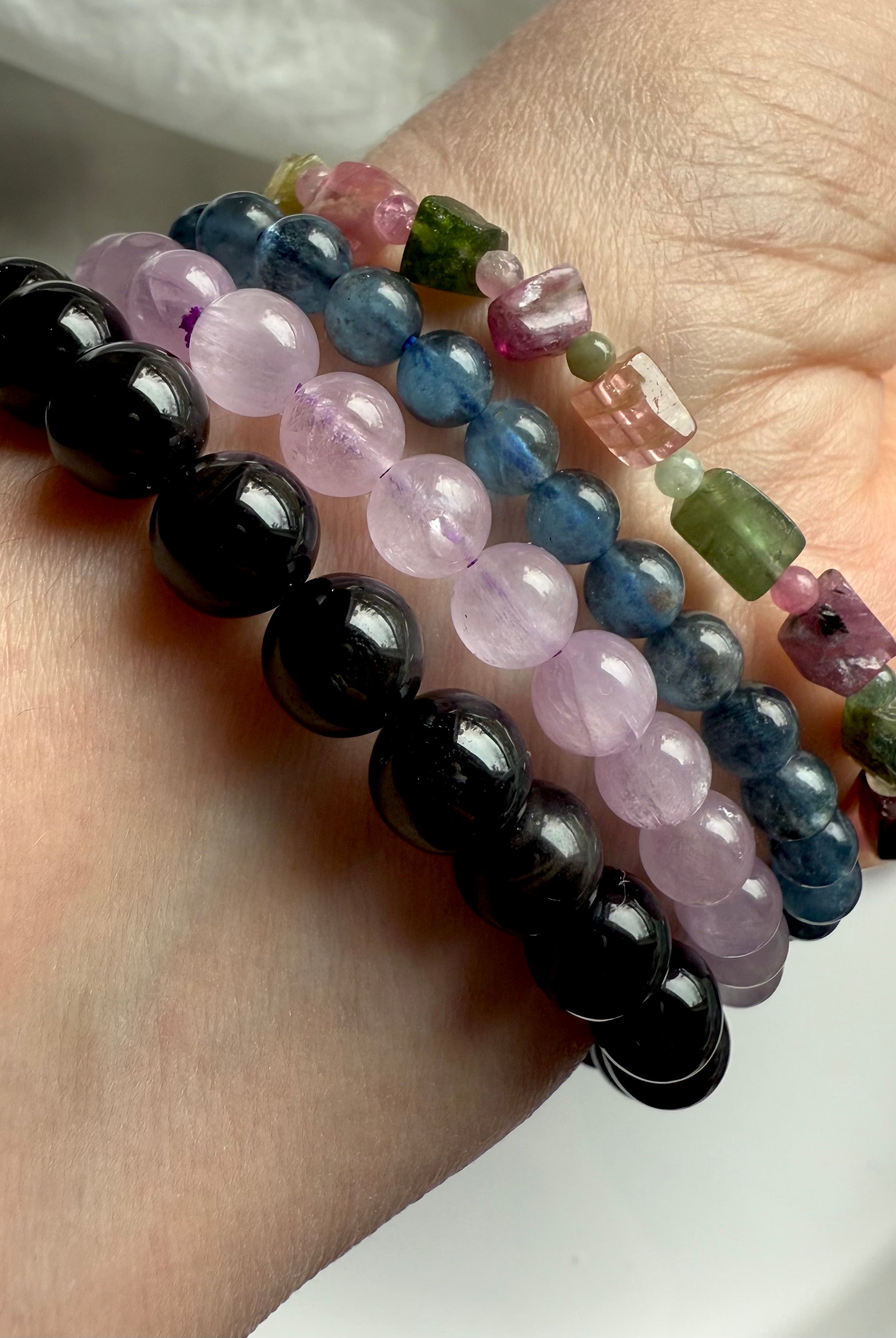 Our Rainbow Tourmaline Cube Bracelet worn with black tigers eye, lilac kunzite + devil aquamarine