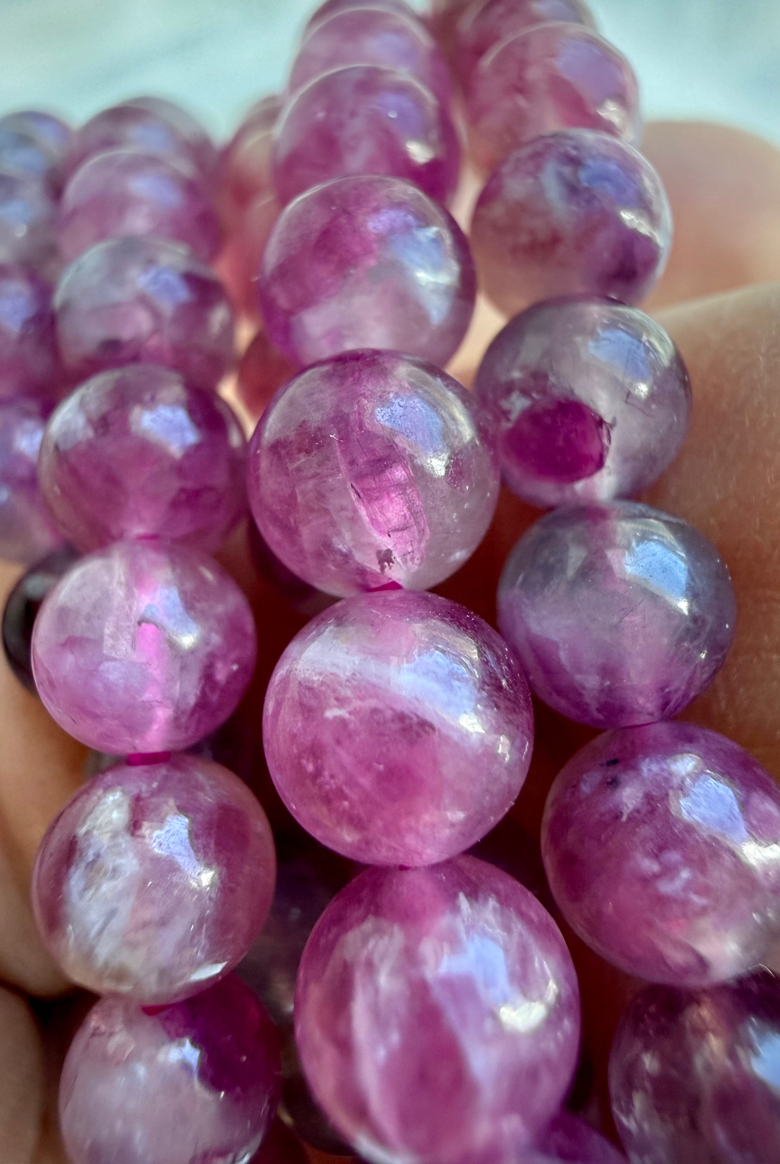 Close-up of Pink Tourmaline gemstone beads with beautiful translucency, internal patterns, and watercolor-like pink tones