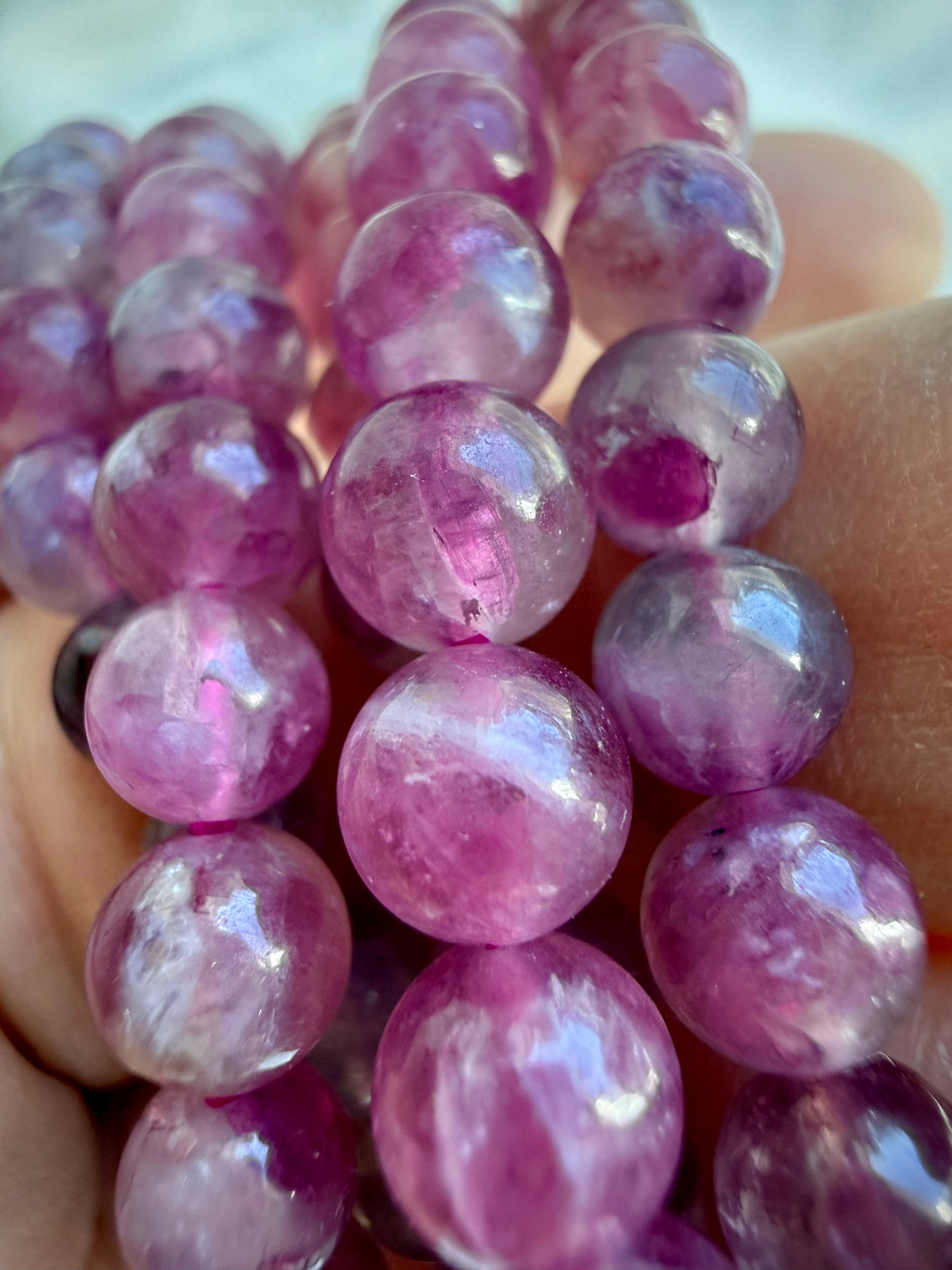 Close-up of Pink Tourmaline gemstone beads with beautiful translucency, internal patterns, and watercolor-like pink tones