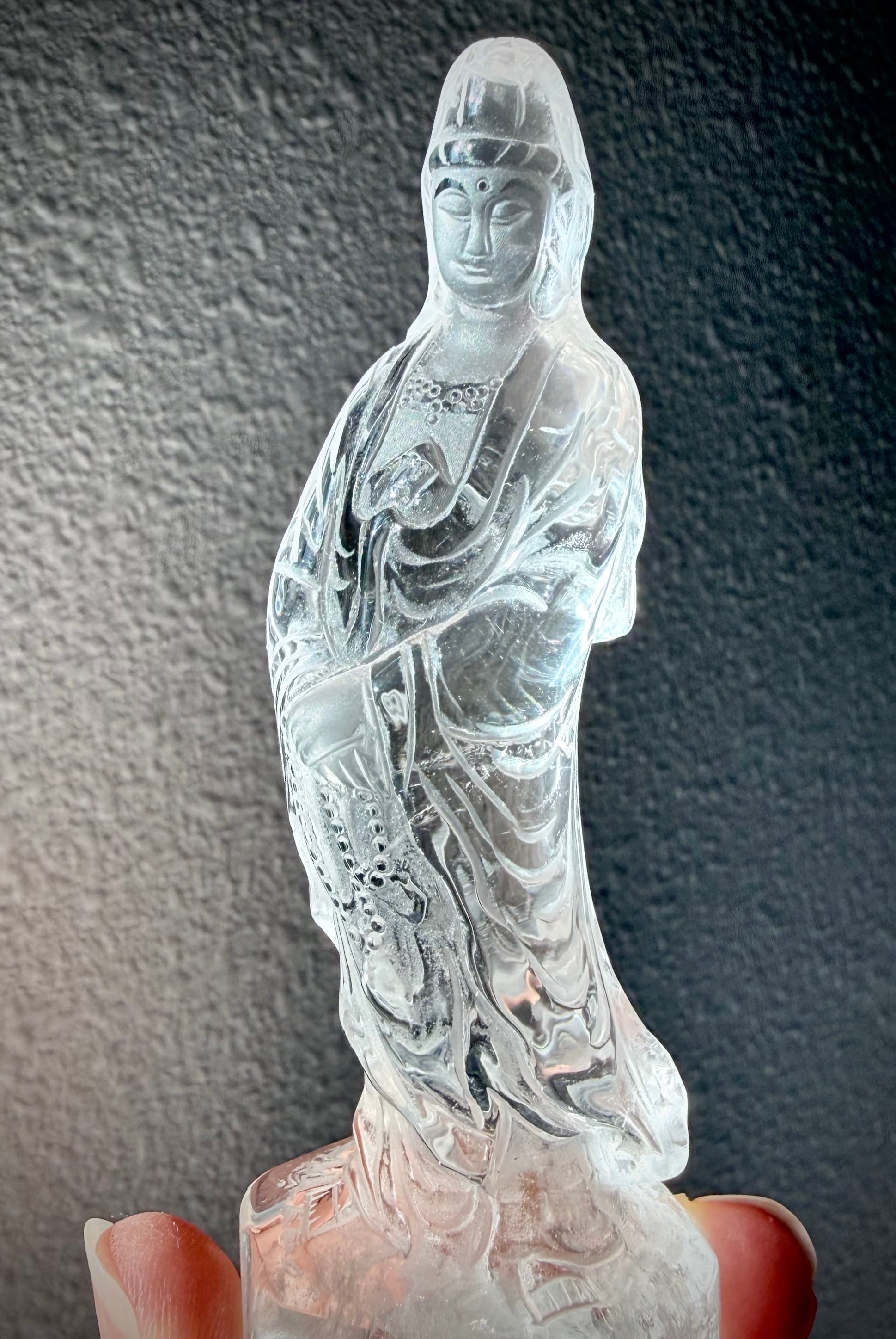 One-of-a-kind Clear Quartz Goddess of Compassion statue with intricate robes and radiant transparency
