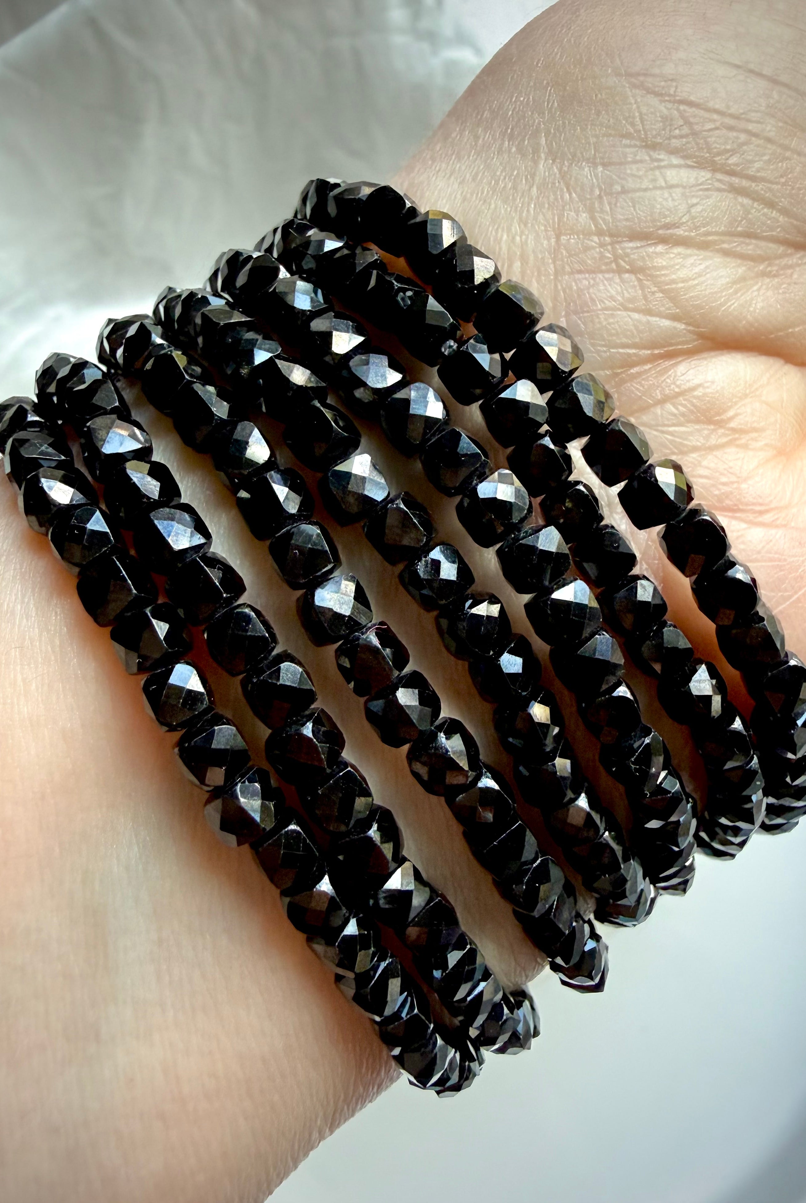 stacked black spinel bracelets on wrist for protection grounding and root chakra energy