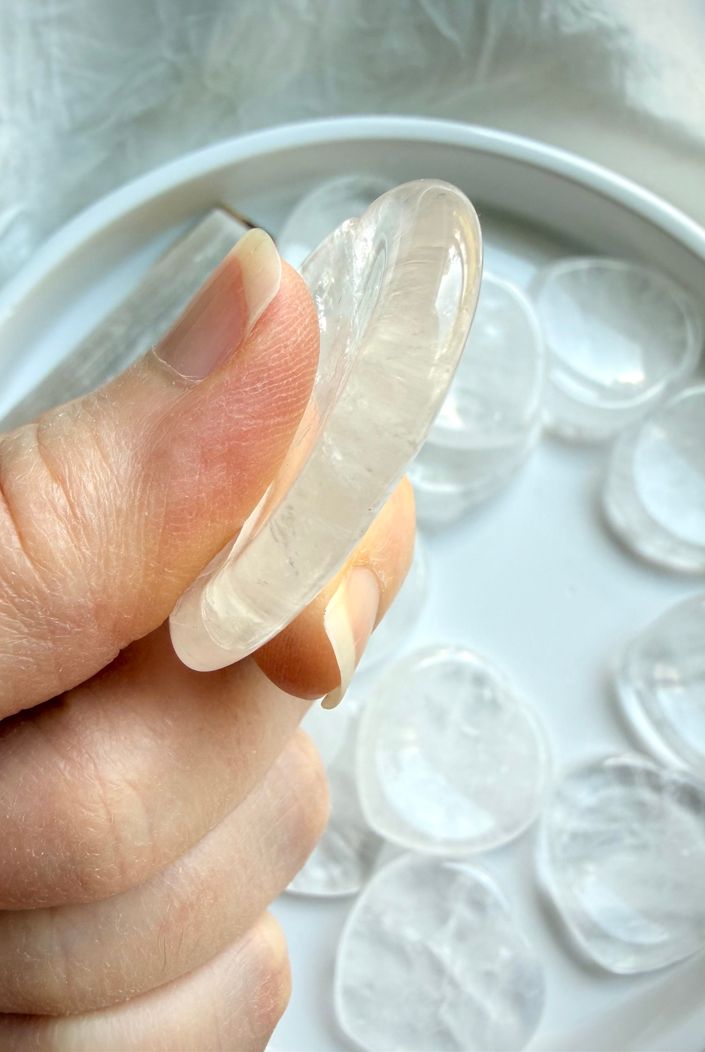 clear quartz heart worry stone side view showing thickness and smooth finish