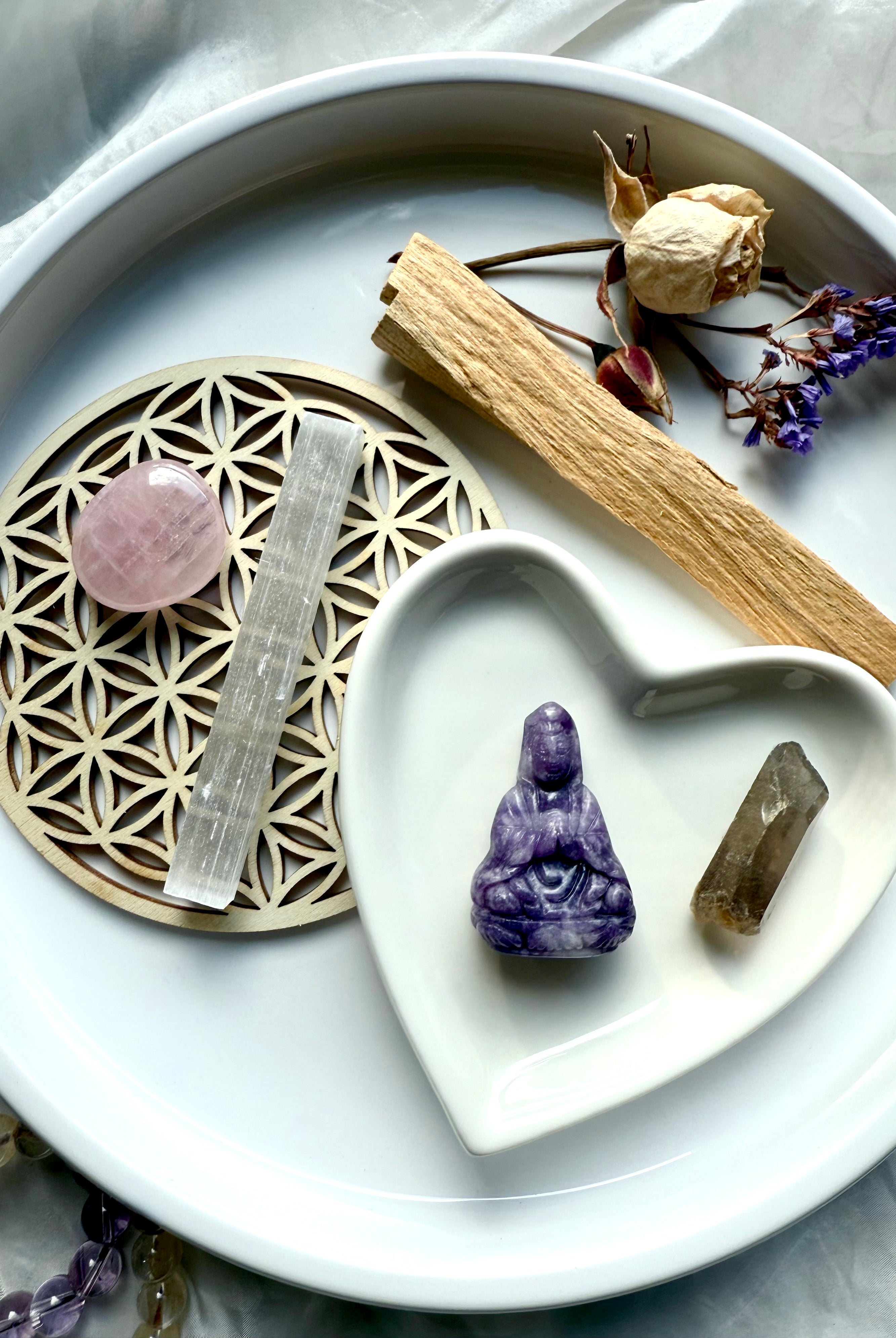 Lepidolite Quan Yin carving with rose quartz, smoky quartz, palo santo, selenite + dried flowers in heart dish on altar tray – crystal gift set for peace and spiritual healing