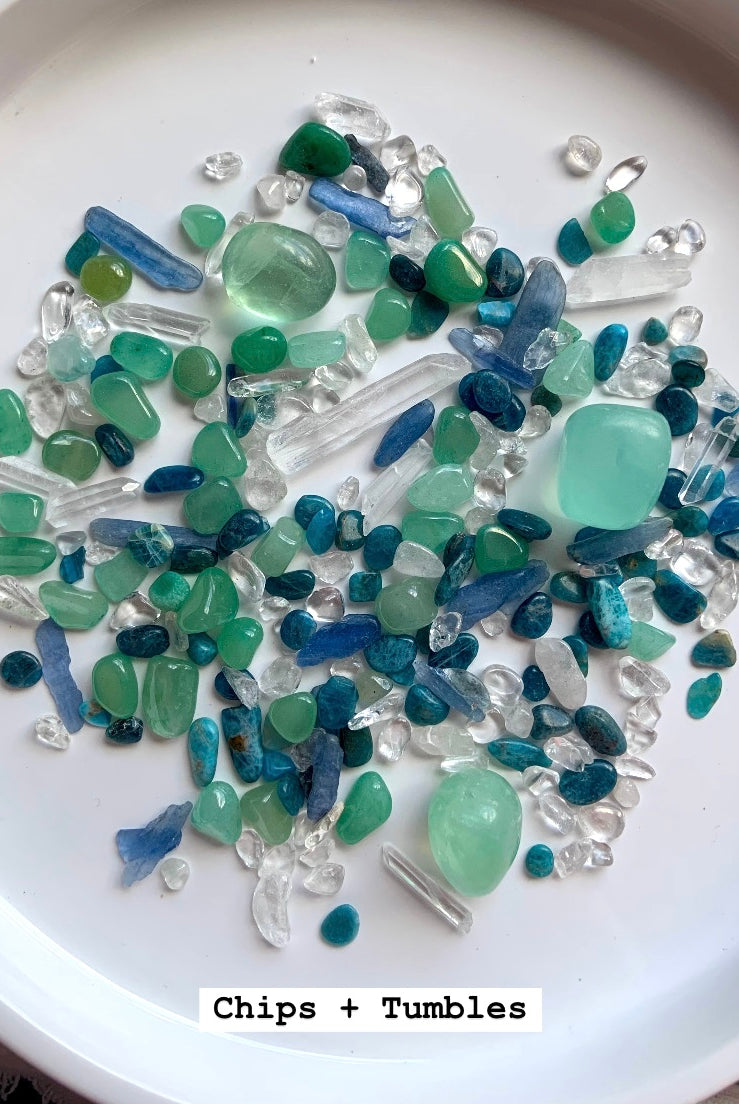 the mermaid crystal confetti mix with chips and tumbles spread on an white plates