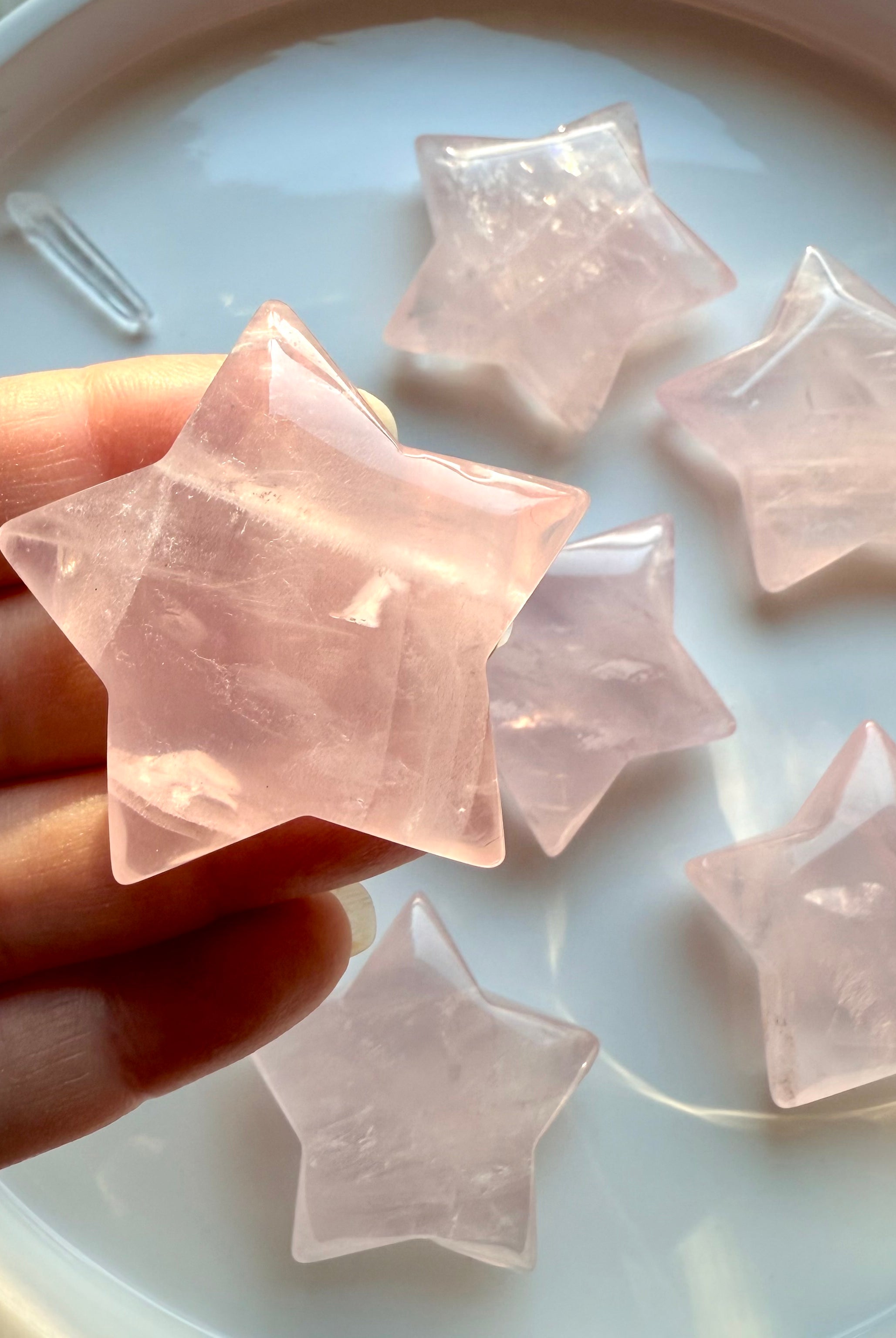 High-clarity Rose Quartz Star from Mozambique with soft translucence and natural inclusions — hand-carved pink crystal star shape.