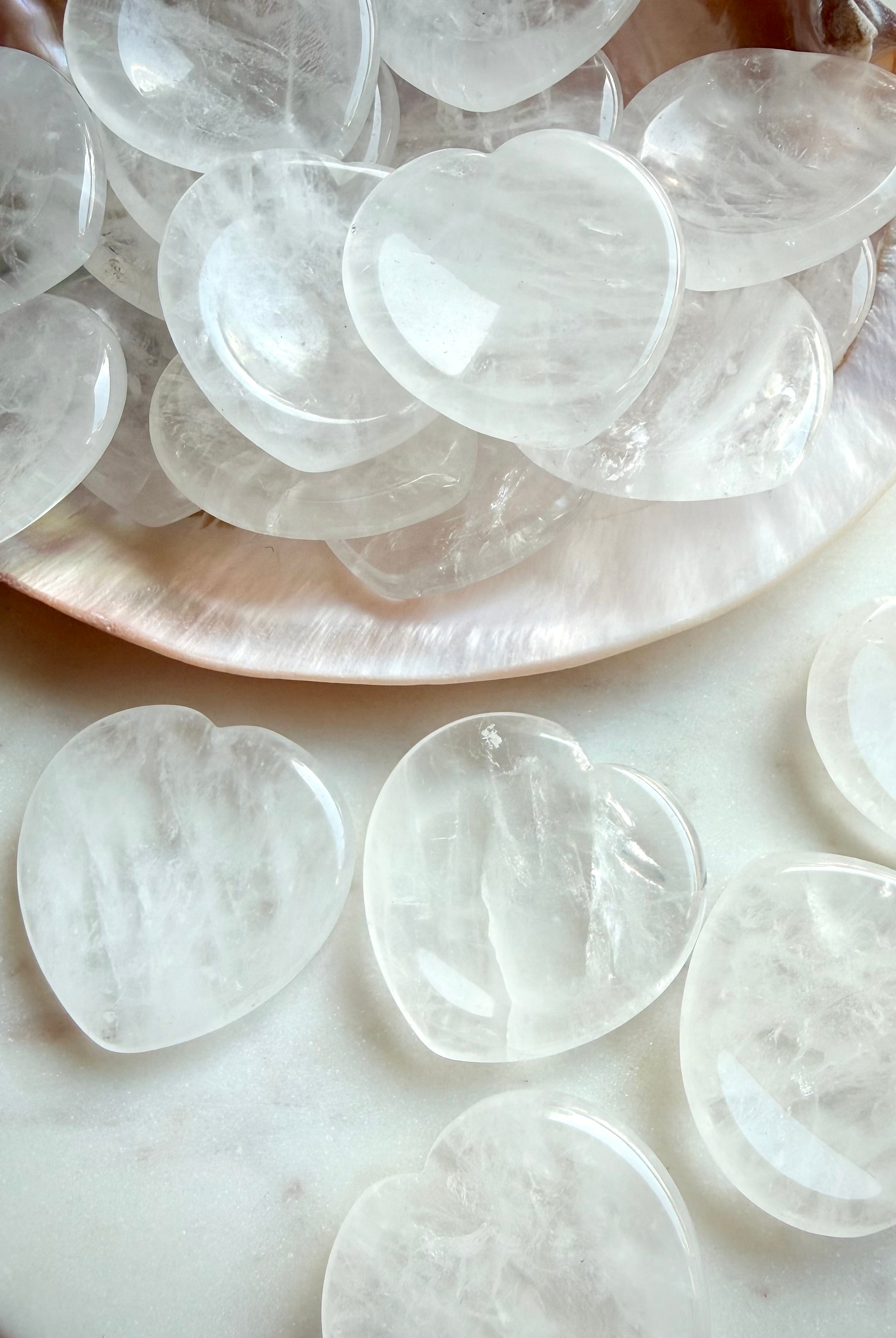 clear quartz heart worry stones close up showing natural inclusions and polished texture