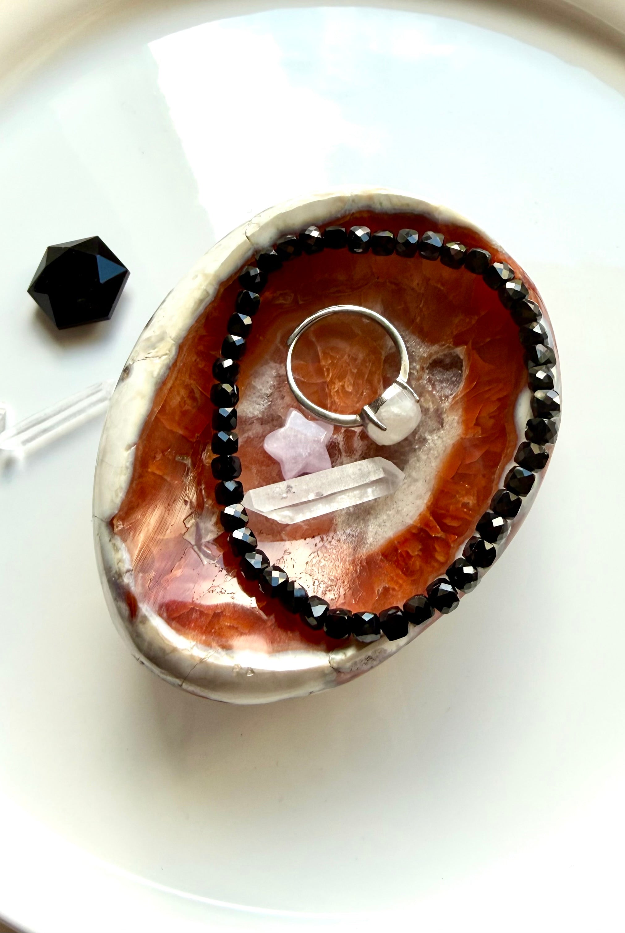 carnelian gemstone bowl used as ring dish with crystals and jewelry display