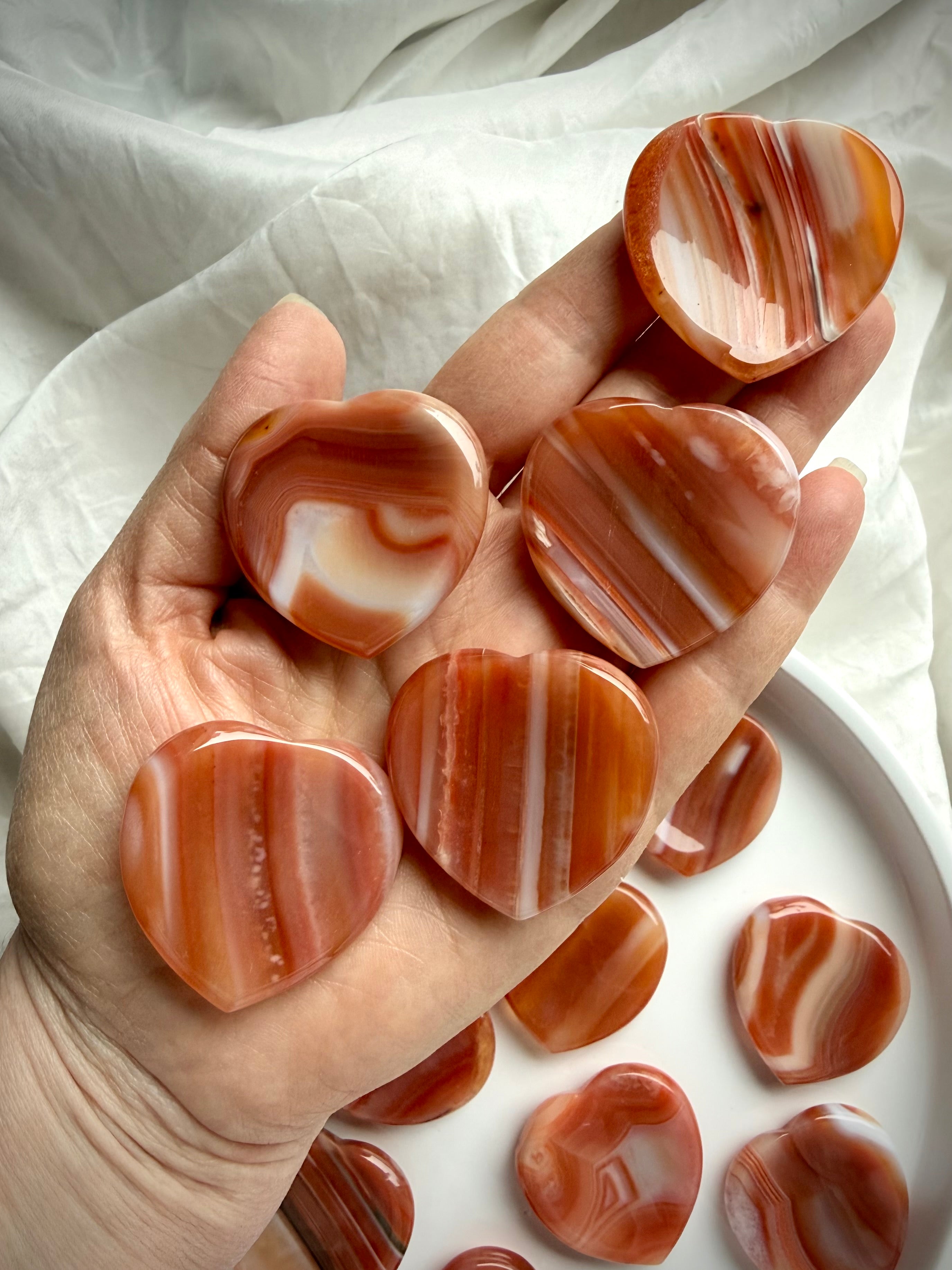Carnelian crystal heart worry stones with natural banding and grounding energy