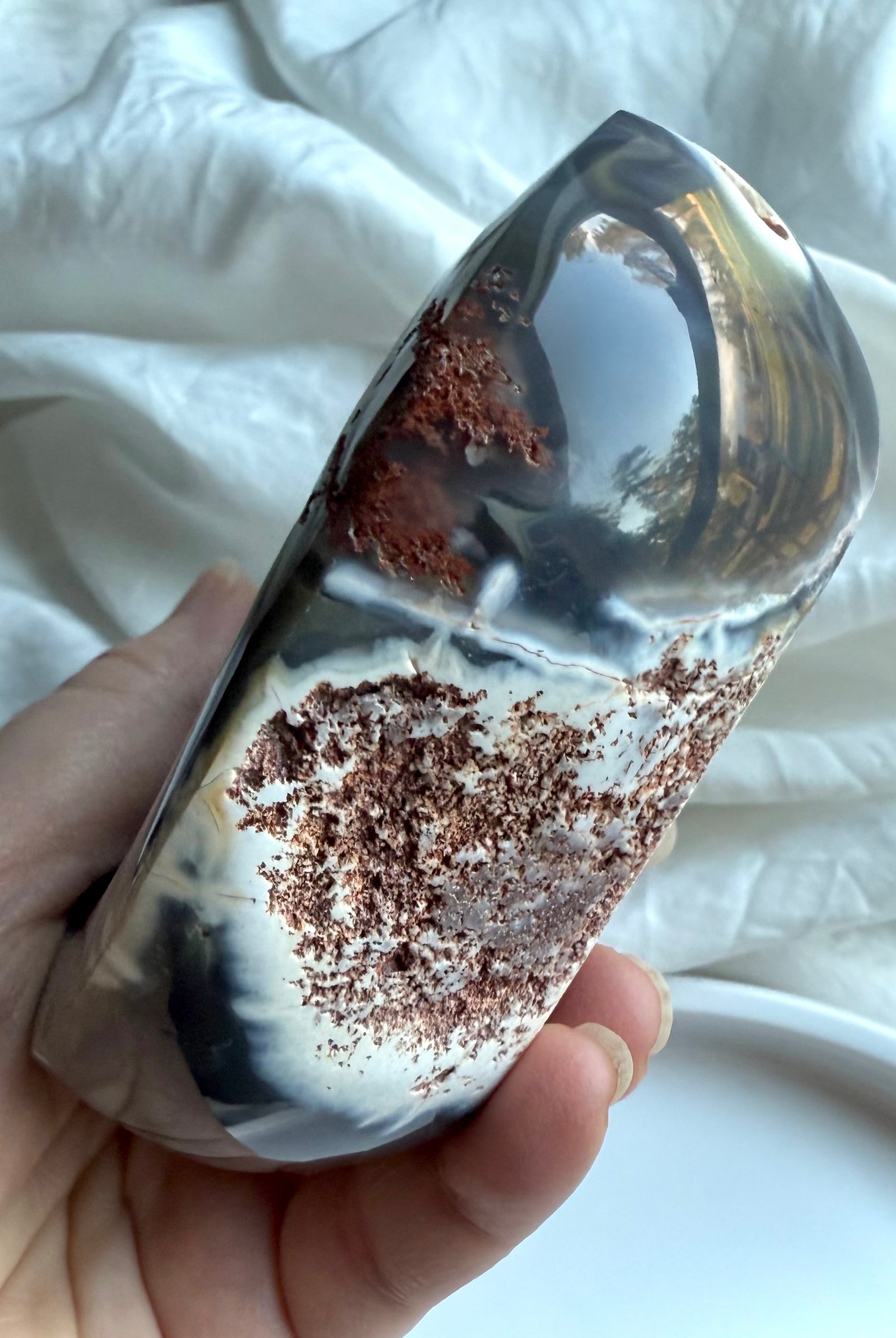 Side view of Orca Agate offering bowl with contrasting polished agate and raw matrix — unique carved crystal bowl for grounding, protection, and sacred rituals.