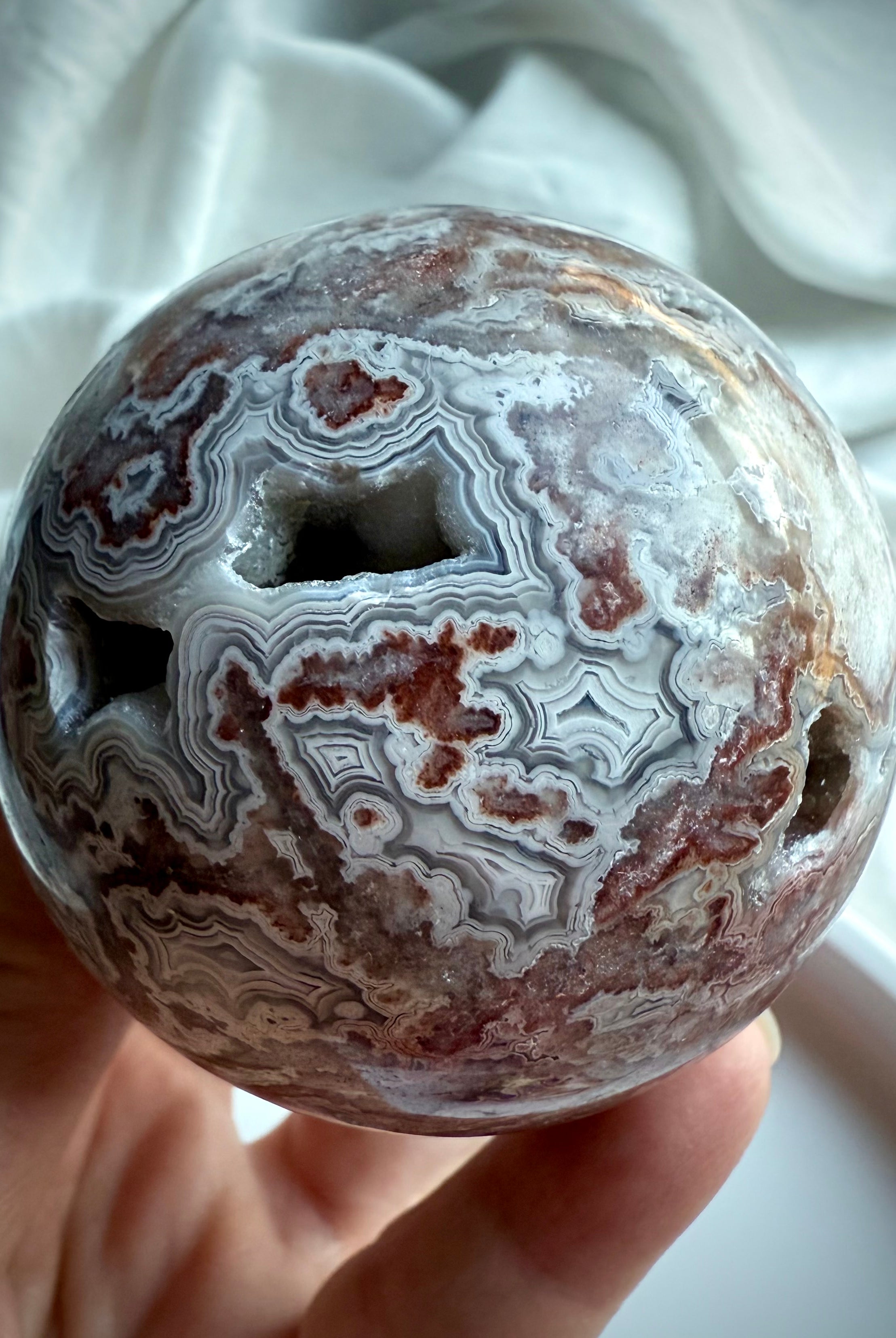 Crazy Lace Agate sphere with druzy pockets and intricate concentric banding for grounding energy