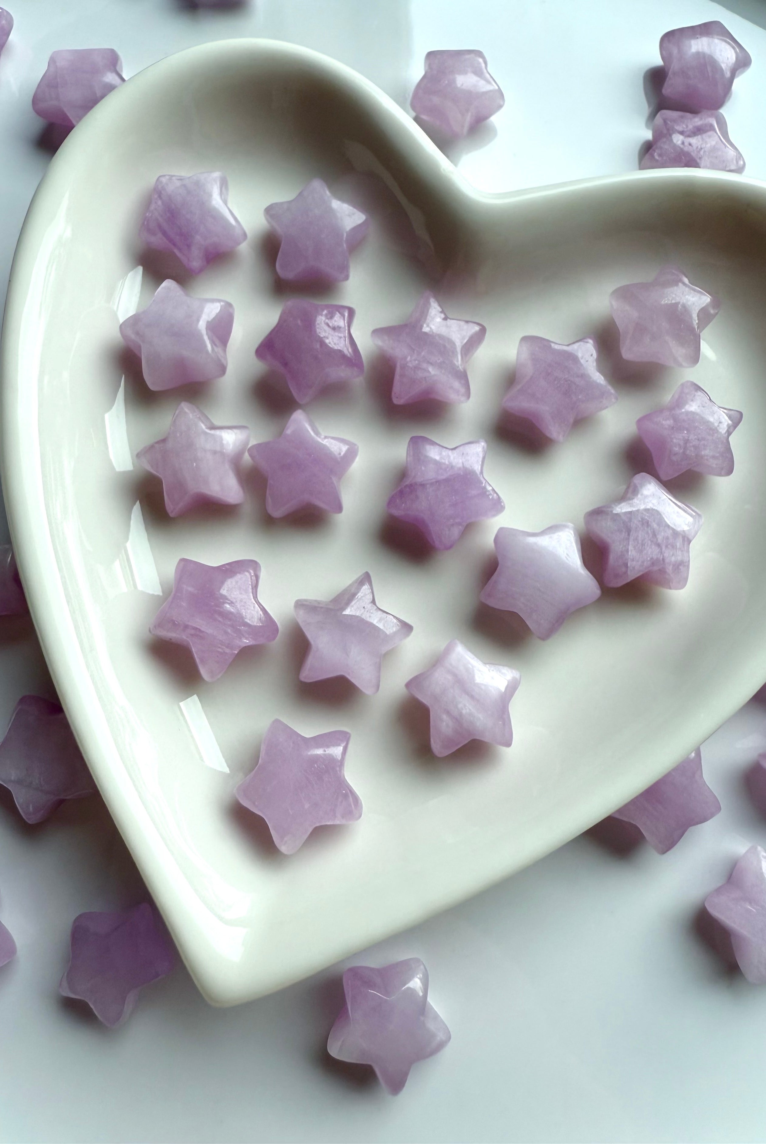 Heart-shaped dish filled with tiny Kunzite mini star carvings in soft lilac hues, heart chakra crystals for divine love and emotional healing.