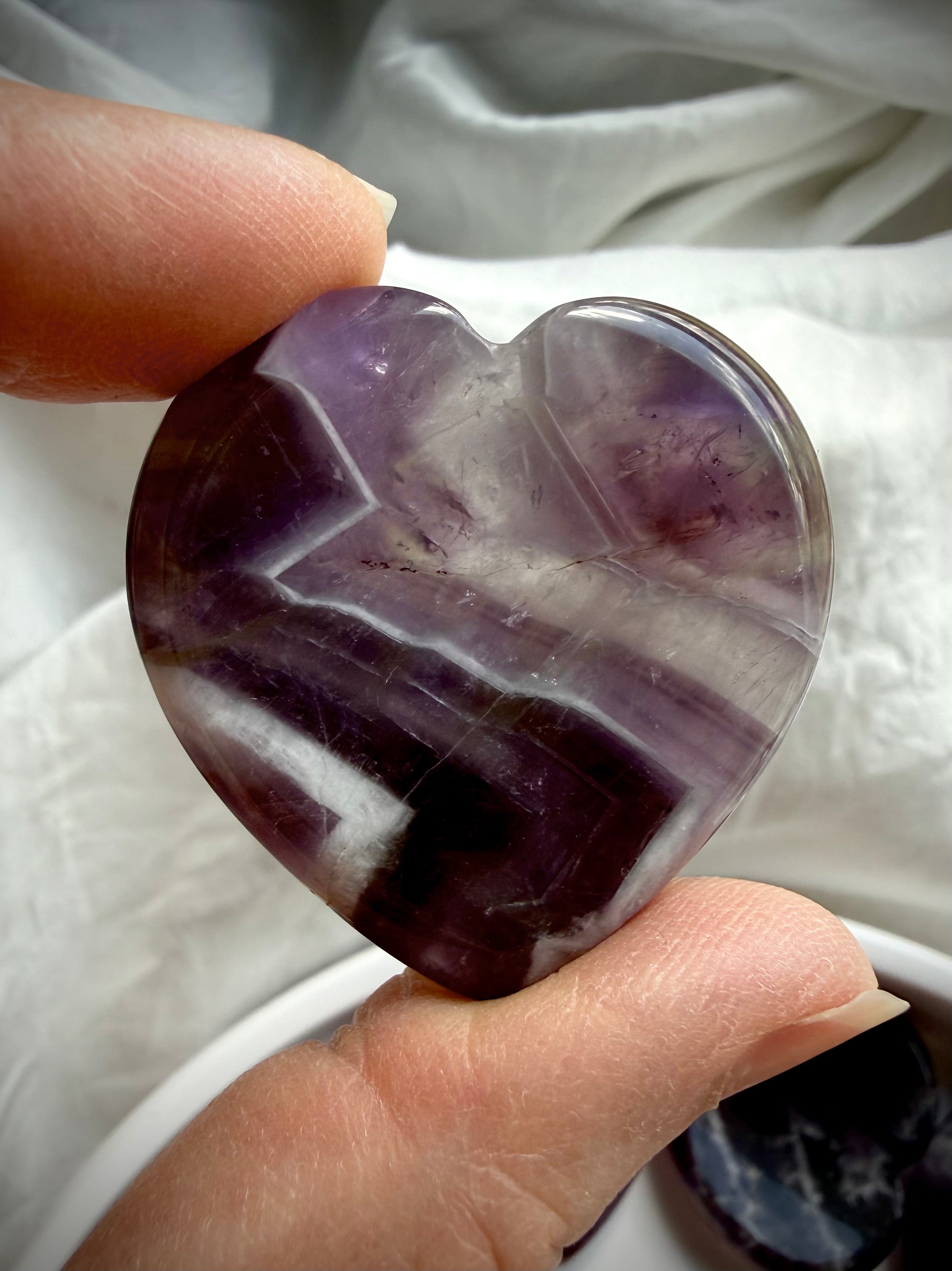 dream amethyst heart palm stone close up for intuition clarity and emotional healing