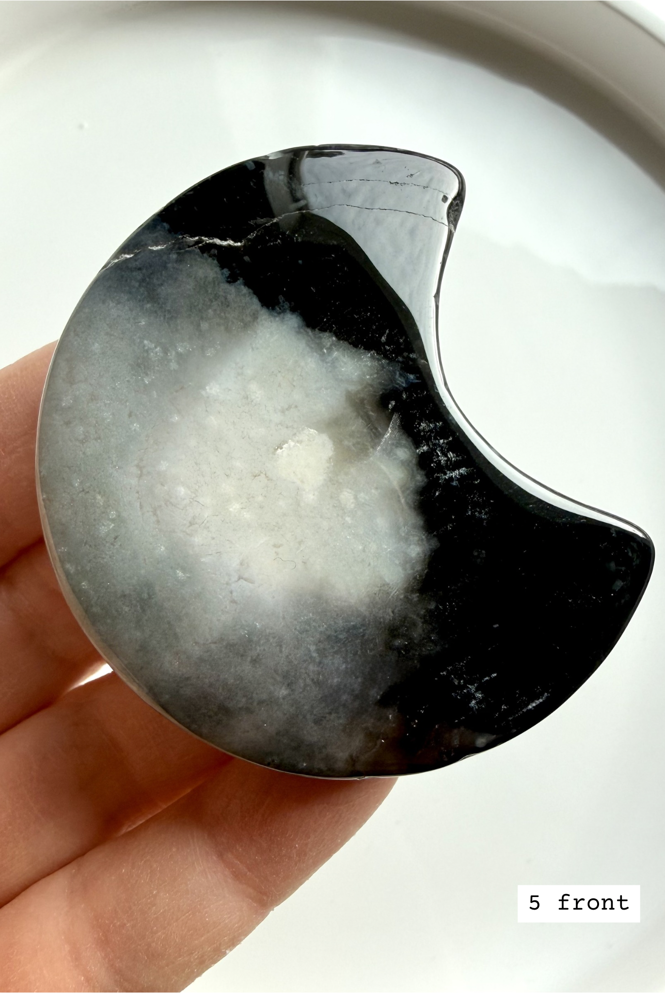 black flower agate moon carving #5 front showing crescent shape with flowing floral plume patterns