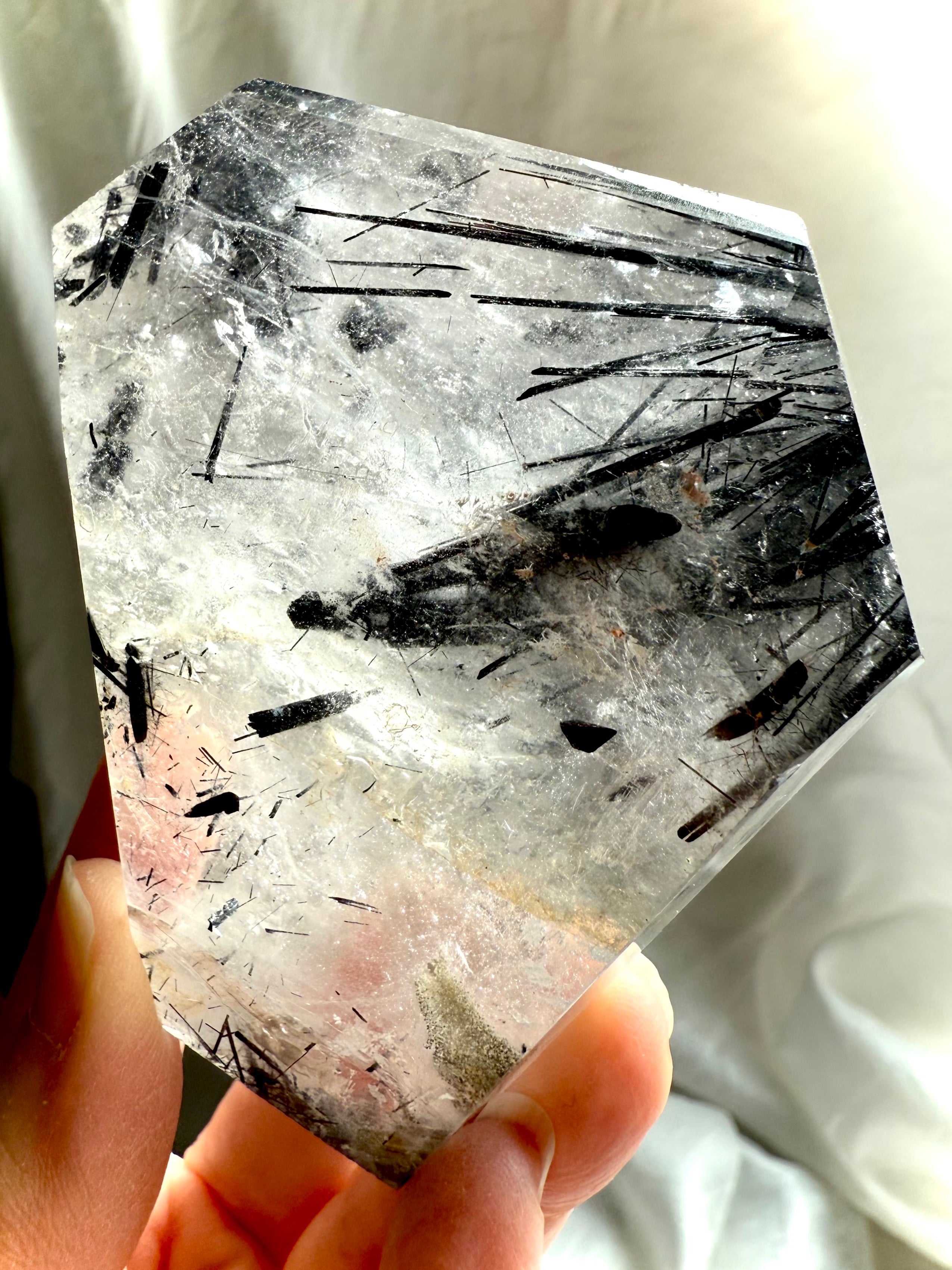 Close-up of Black Tourmaline needles inside clear Quartz crystal, natural tourmalinated quartz detail
