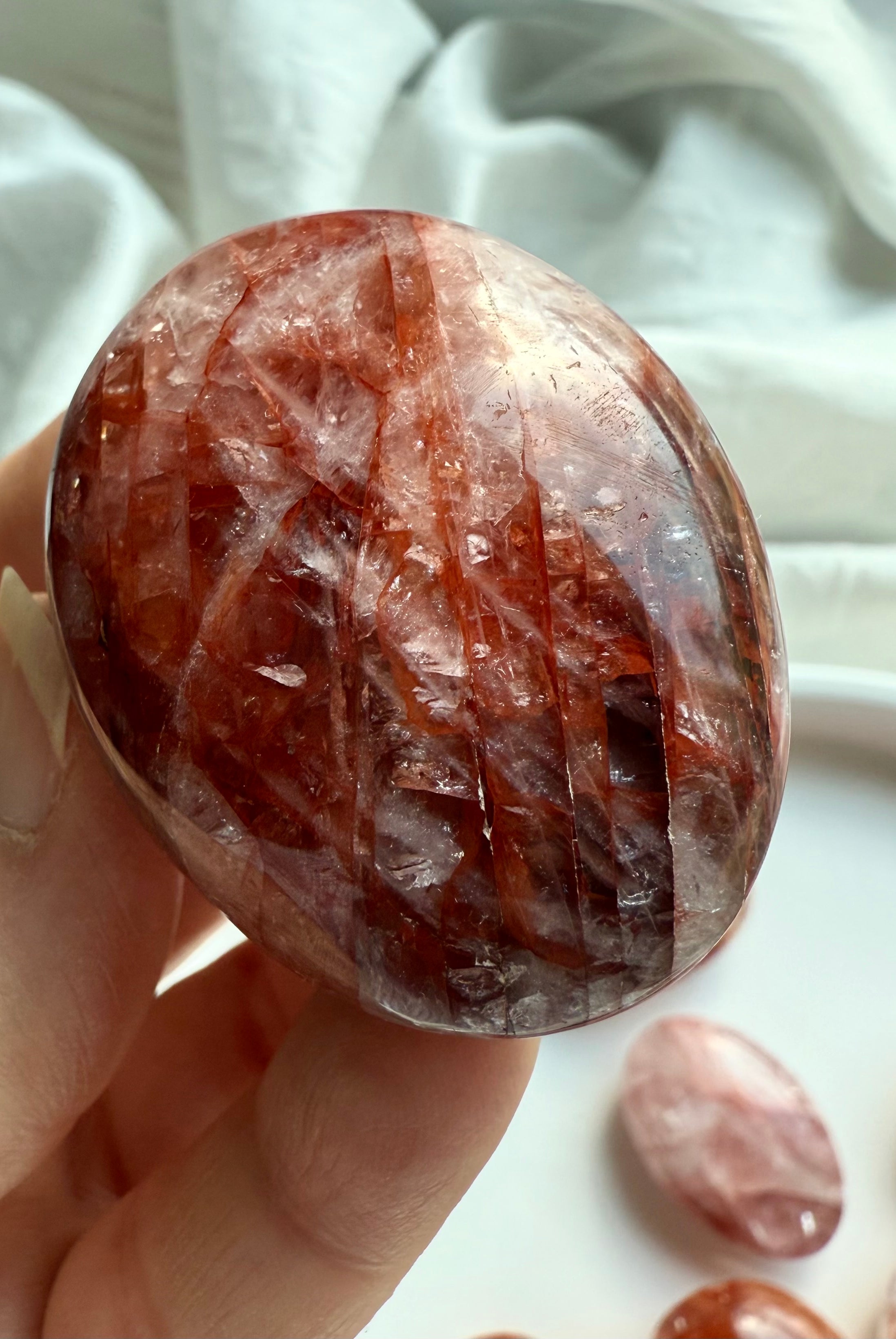 Hematoid Quartz palm stone with red hematite inclusions for grounding, courage, and transformation