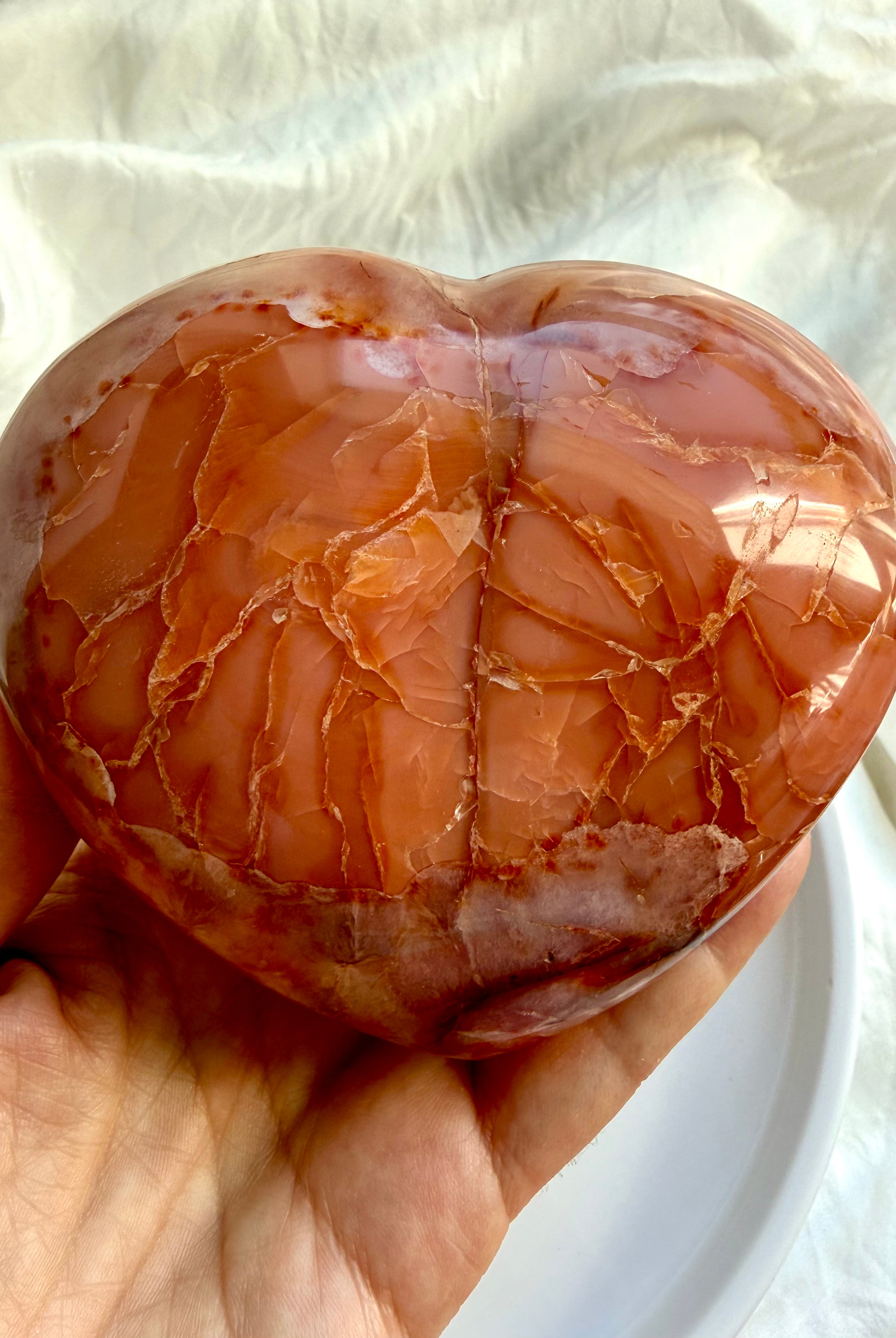 Back angle of one of a kind Carnelian geode heart showing natural color variation and banding