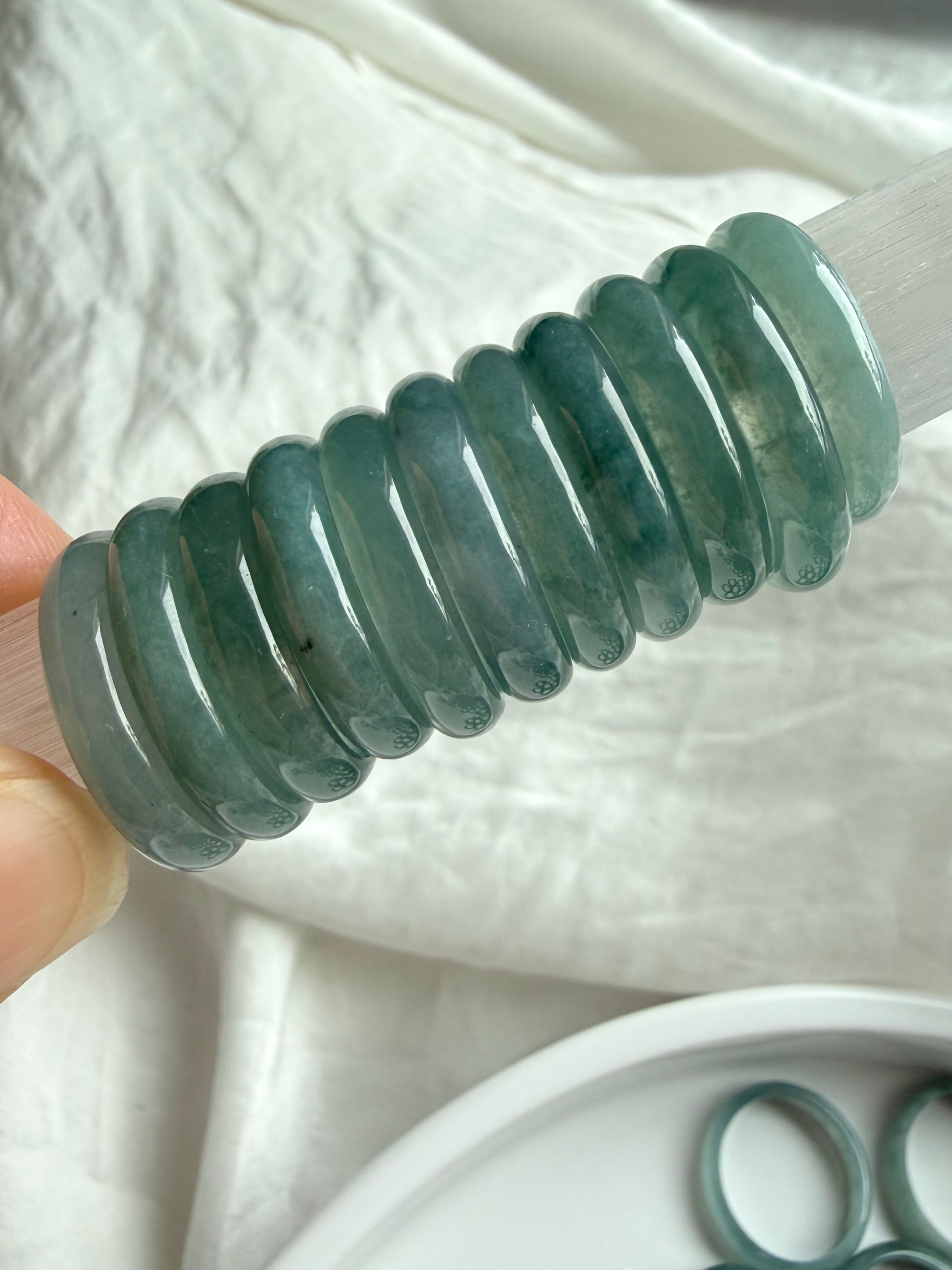 Stacked rounded jadeite band rings showing thickness and polish of Blue Water jade