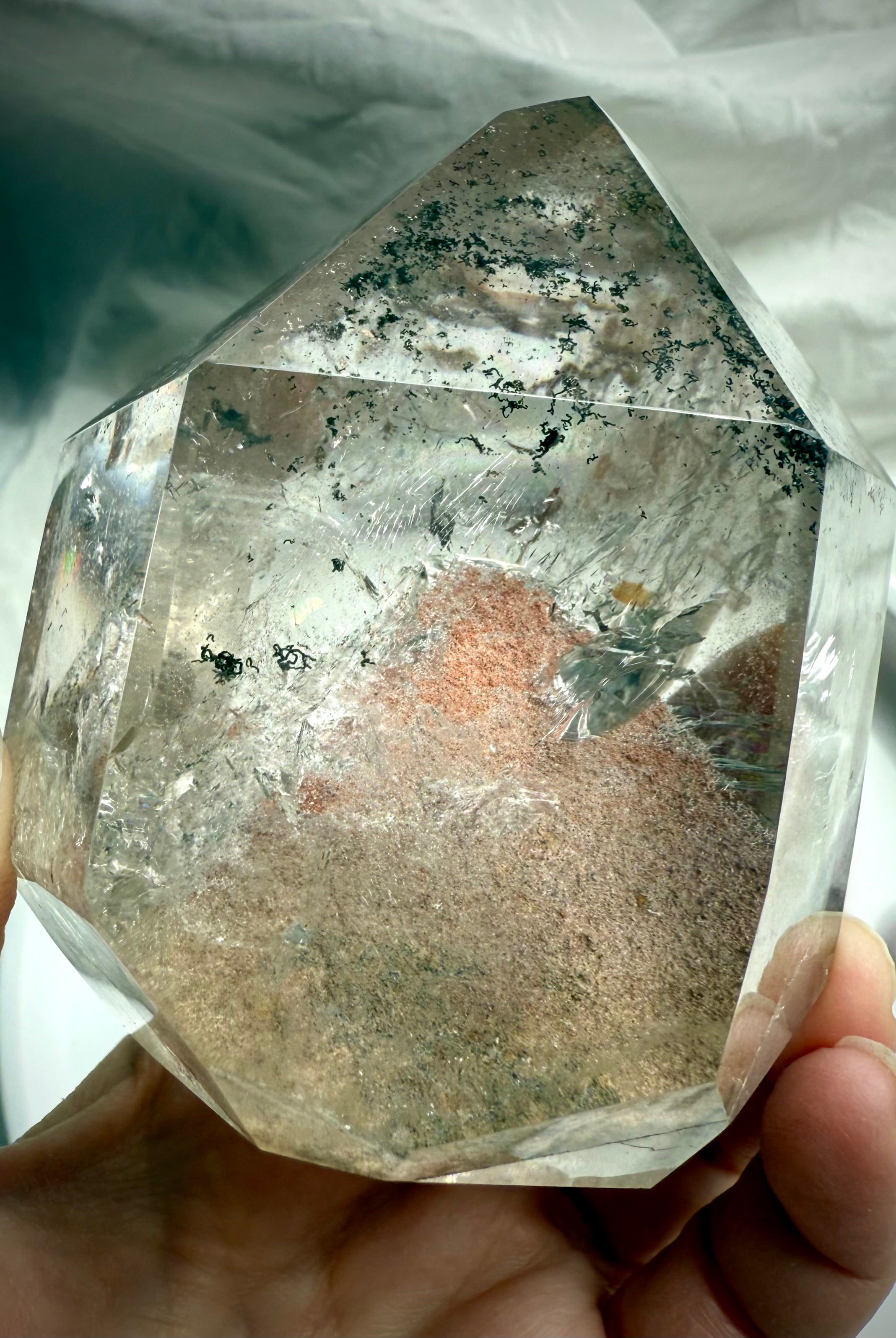 A polished Garden Quartz Crystal with a big phantom pyramid, green chlorite phantom lines + rainbows