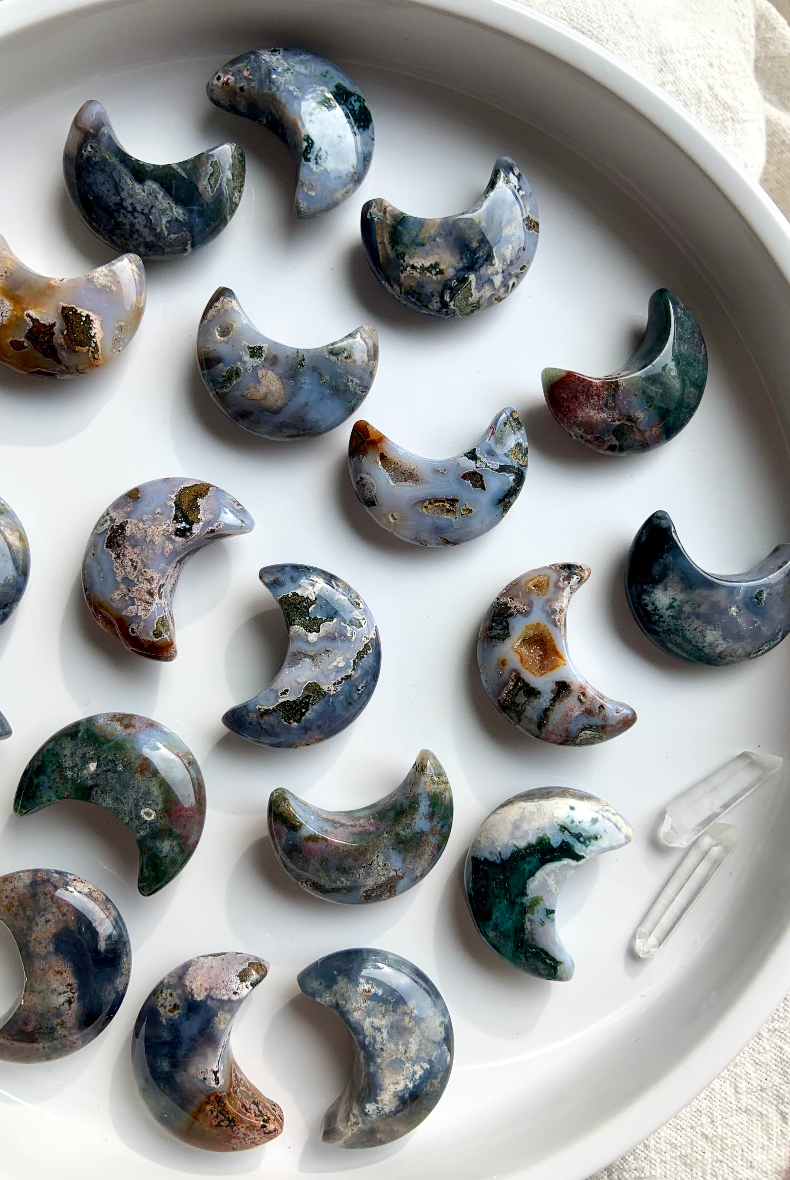 Cosmic Ocean Jasper moons crystal carvings on white background