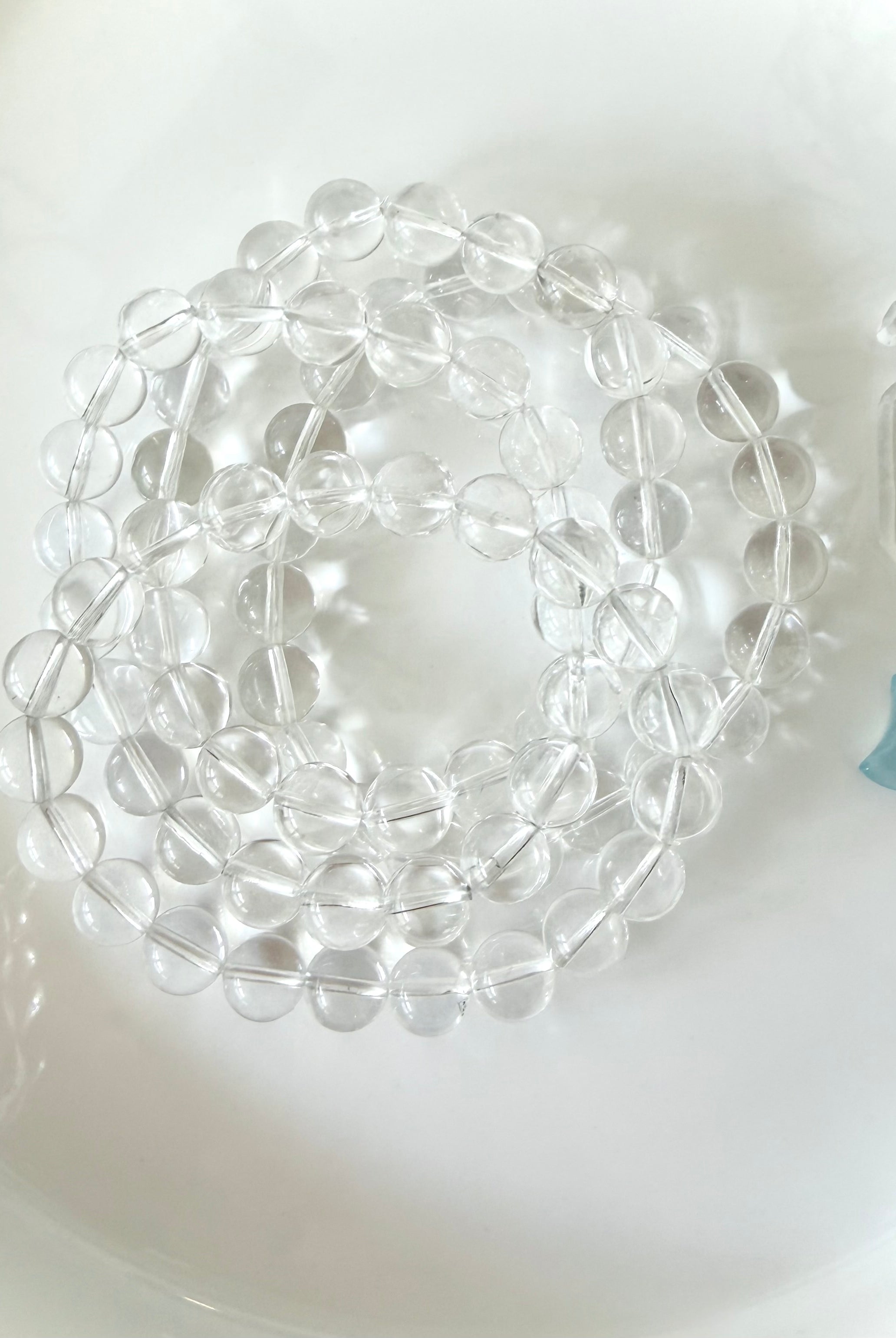 High clarity Clear Quartz bracelets displayed in hand with sparkling transparent crystal beads and polished finish