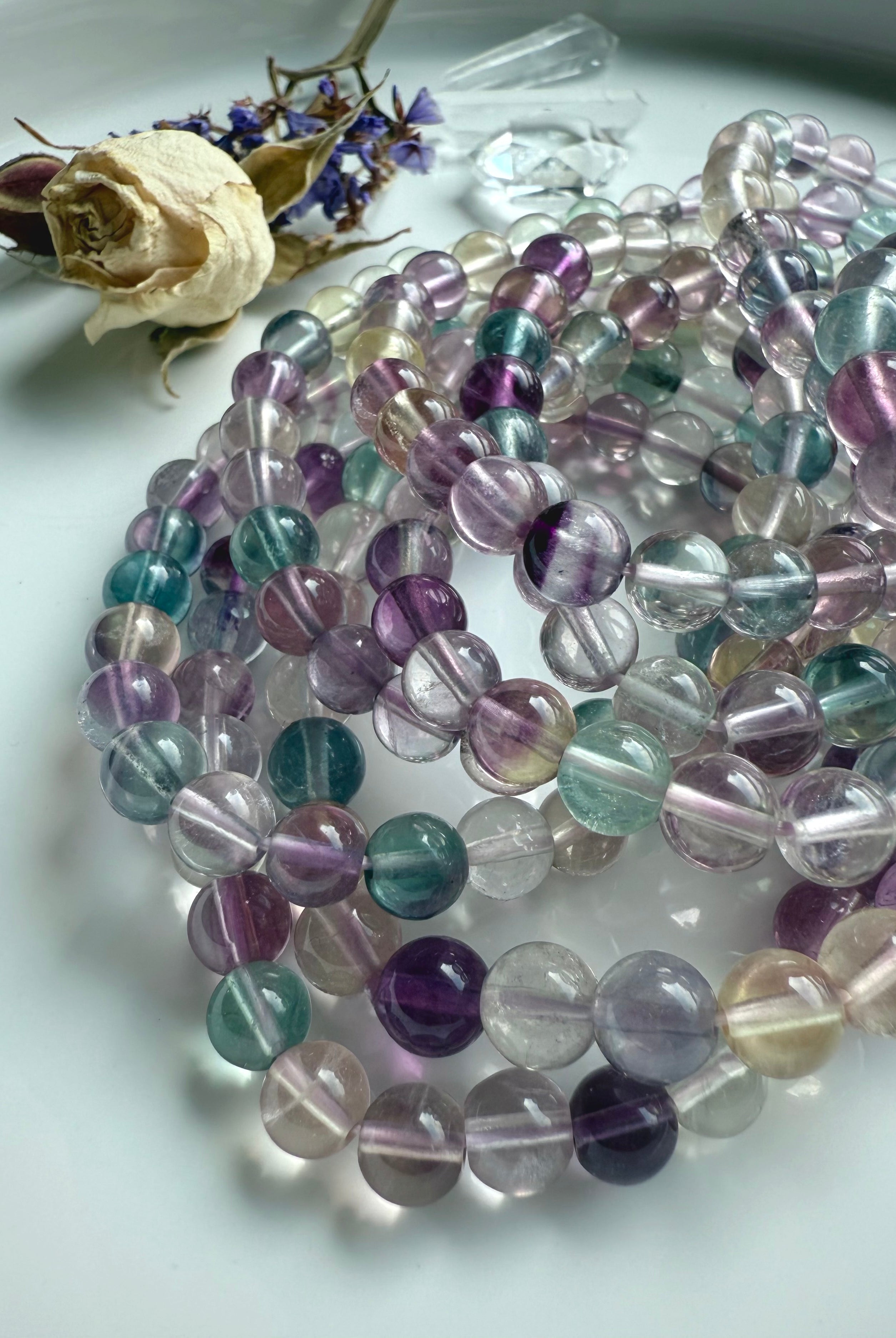Mixed color fluorite bracelet coiled to highlight bead quality and smooth polished finish