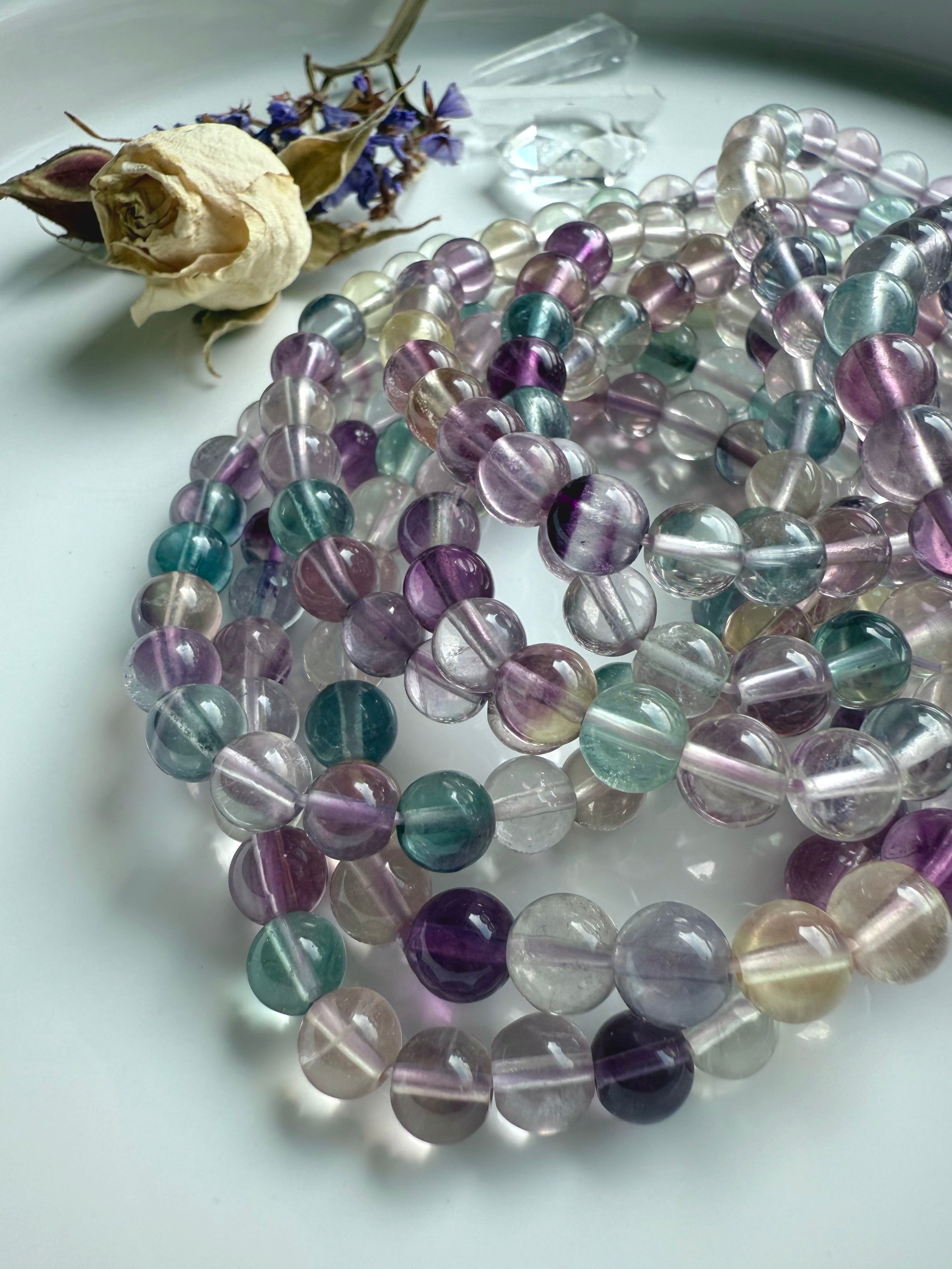 Mixed color fluorite bracelet coiled to highlight bead quality and smooth polished finish