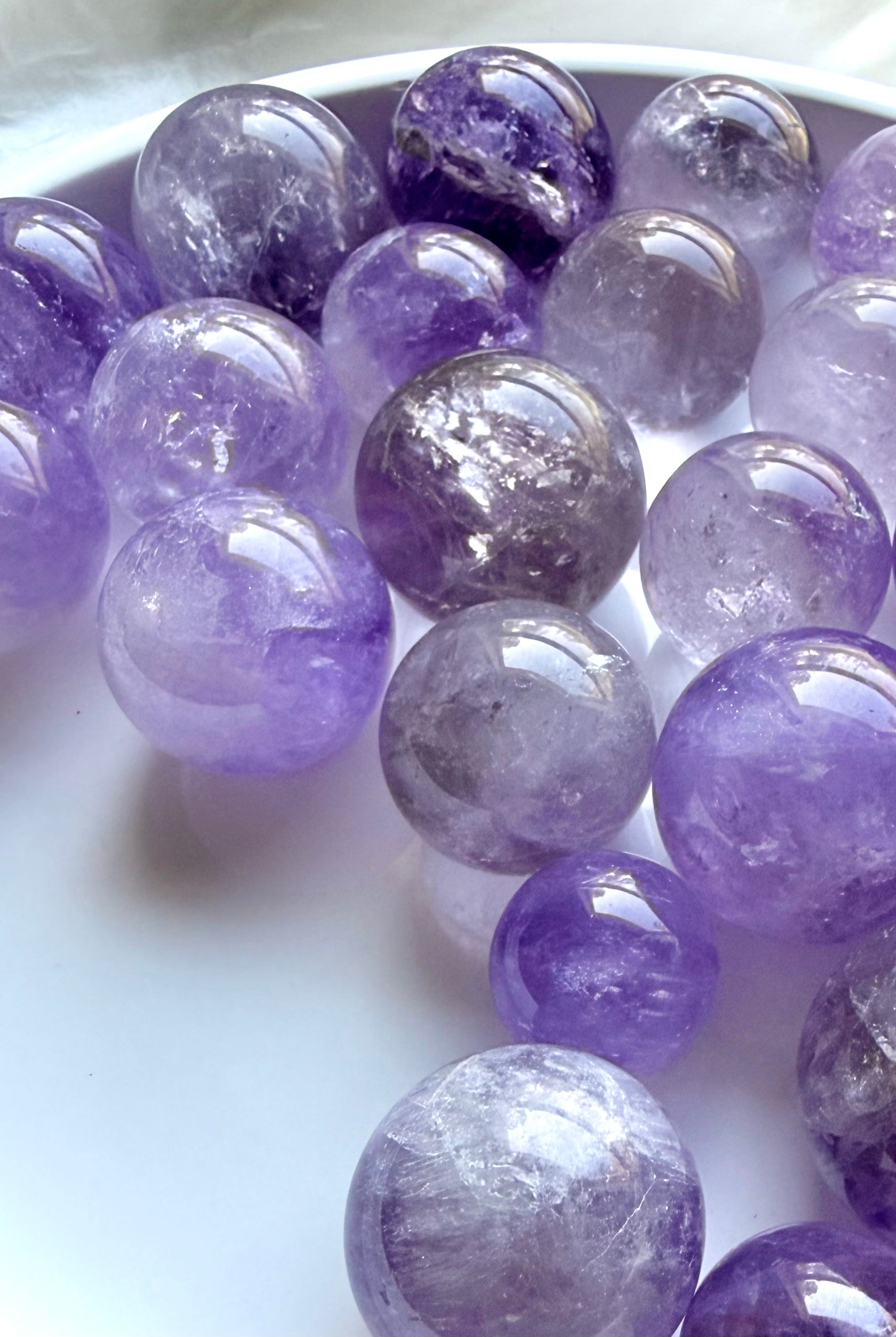 smoky amethyst crystal spheres assortment with pale lavender to deep purple tones