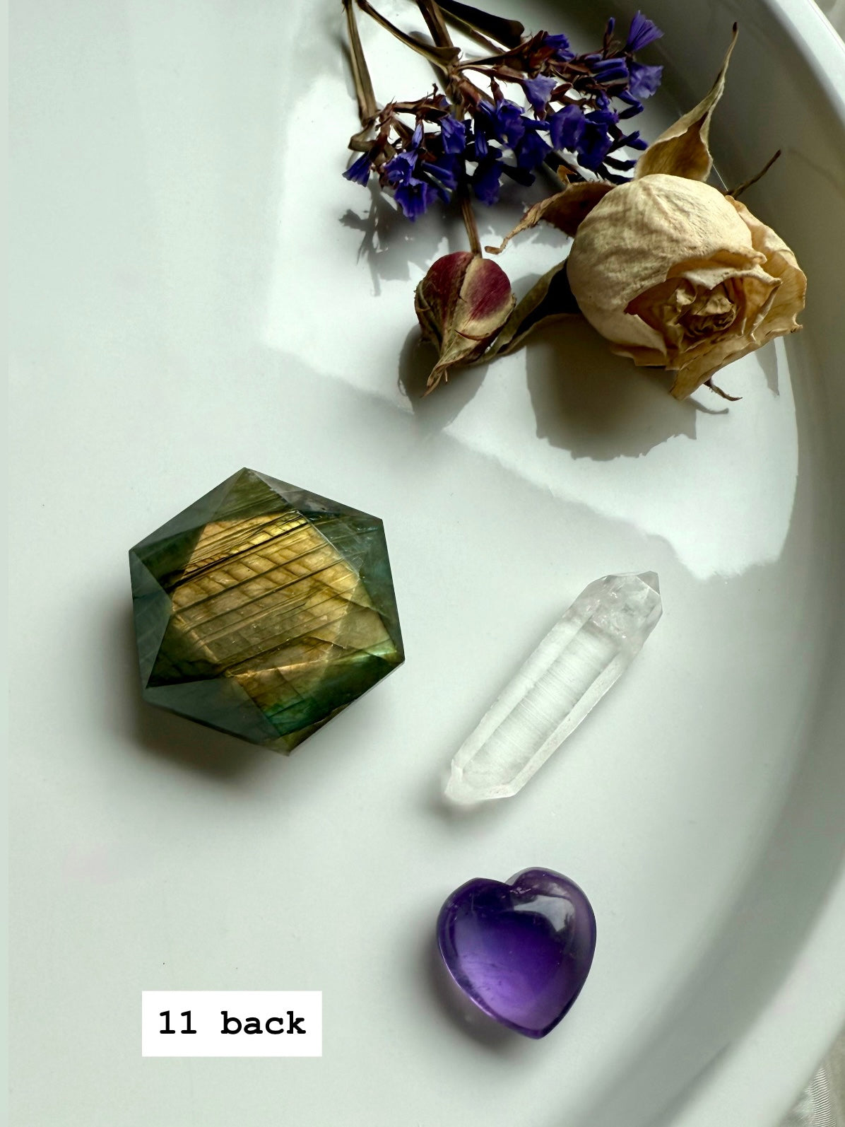Faceted Labradorite hexagon gemstone showing rainbow flash and reflective polish.